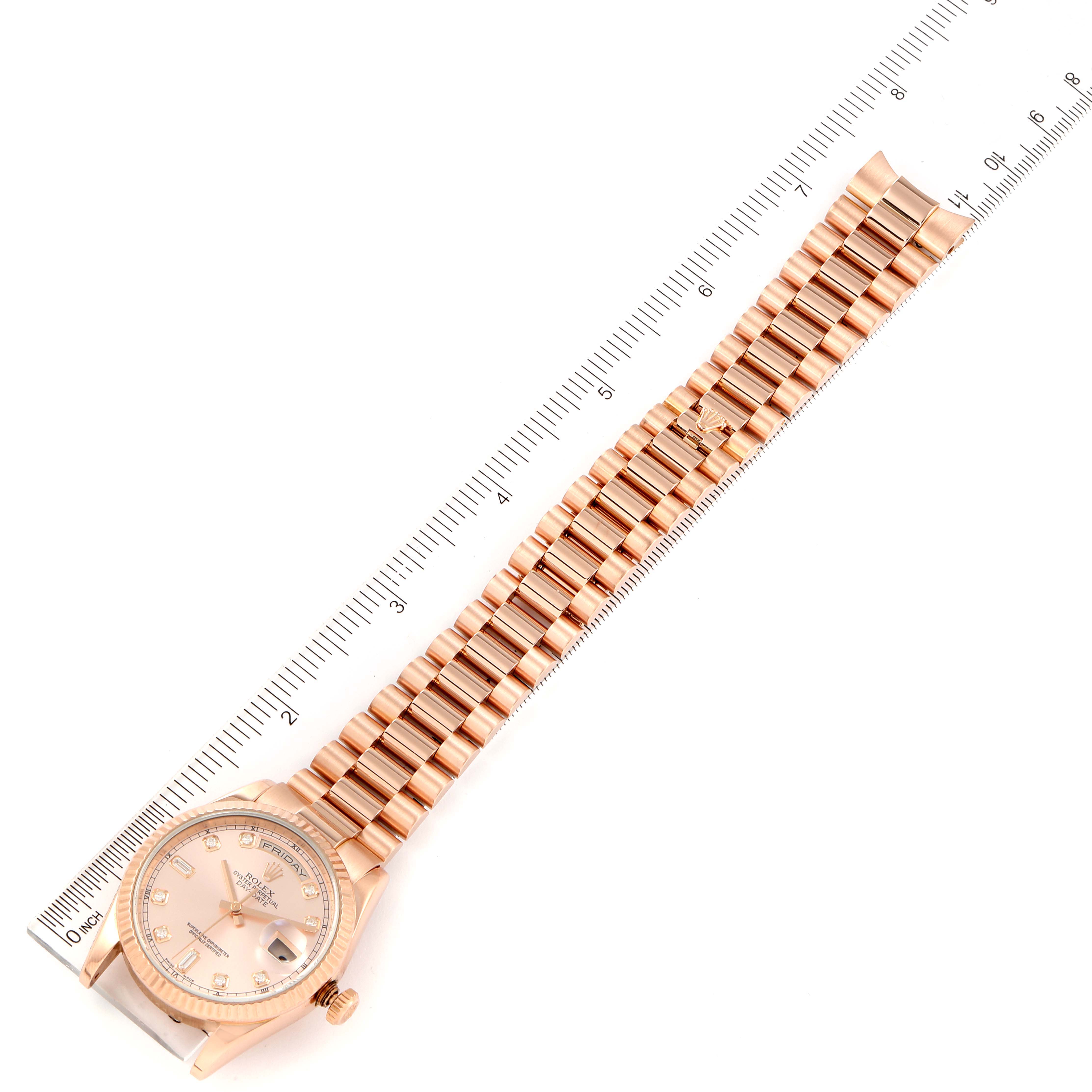 The image shows a Rolex President 118235 Men's Rose Gold Pink Dial 118235 Men's Rose Gold Pink Dial model watch laid out flat with a ruler measuring its length.