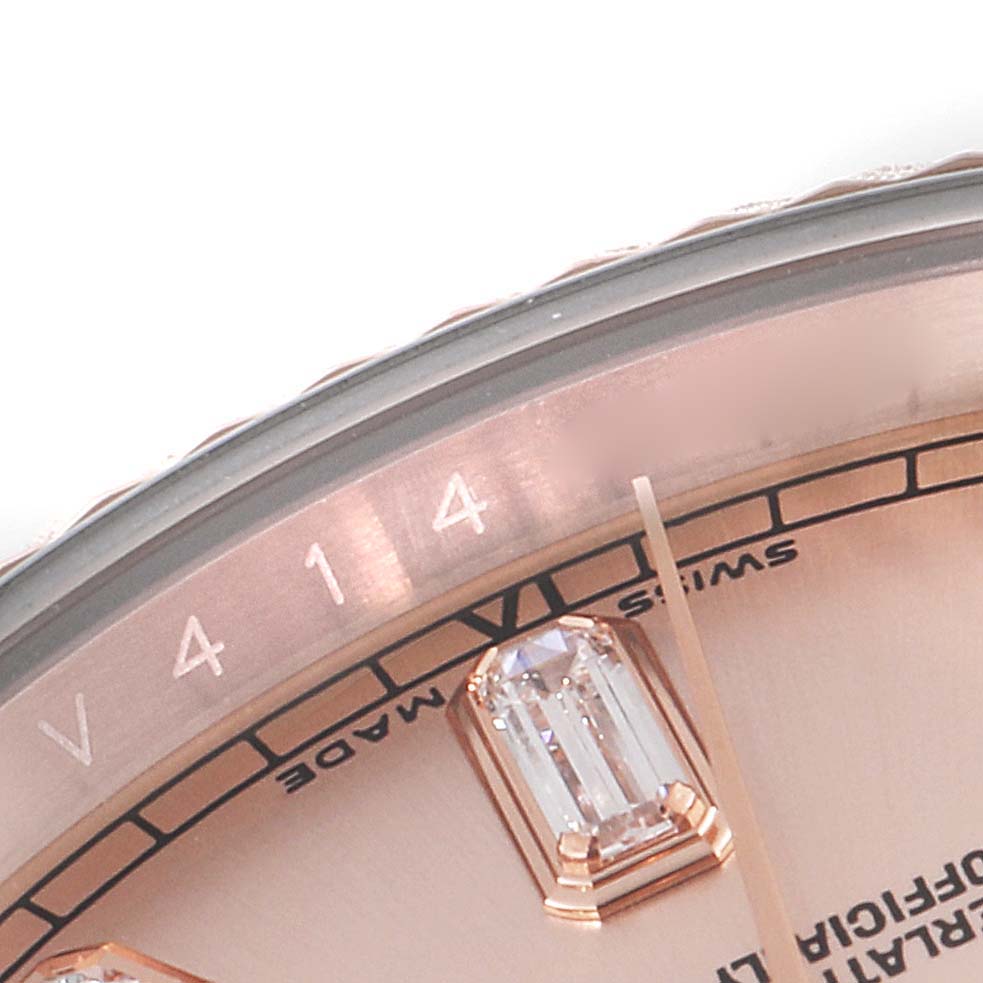 This close-up image of a Rolex President 118235 Men's Rose Gold Pink Dial 118235 Men's Rose Gold Pink Dial model watch shows part of the dial with a diamond hour marker and serial number.