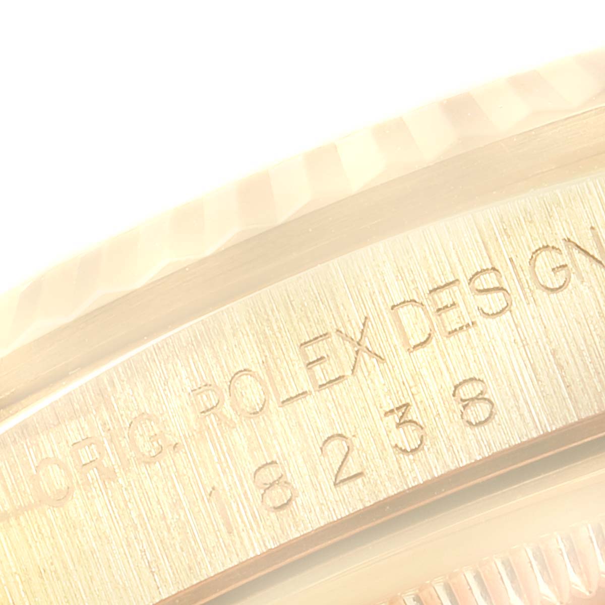This close-up angle shows the engraved case back and fluted bezel of a Rolex President 18238 Men's Yellow Gold Champagne Dial 18238 Men's Yellow Gold Champagne Dial model watch.