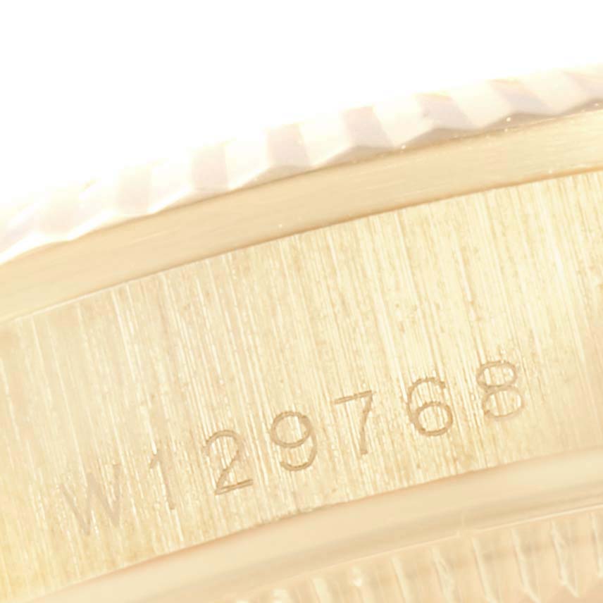 This image shows a close-up of the Rolex President 68278 Women
s Yellow Gold Champagne Dial 68278 Women
s Yellow Gold Champagne Dial model
s case, featuring its serial number engraved on the side.