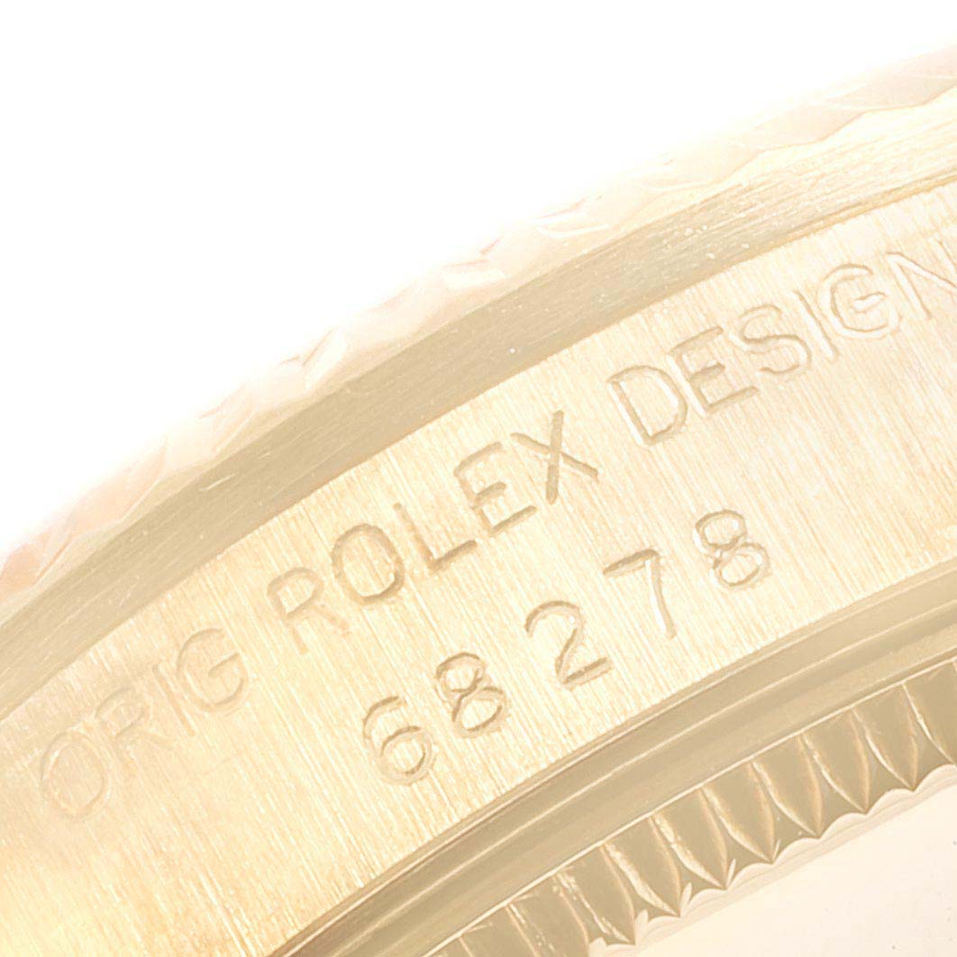 The image shows a close-up of the side engraving on a Rolex President 68278 Women
s Yellow Gold Champagne Dial 68278 Women
s Yellow Gold Champagne Dial model, displaying the "ORIG ROLEX DESIGN" text and part number.