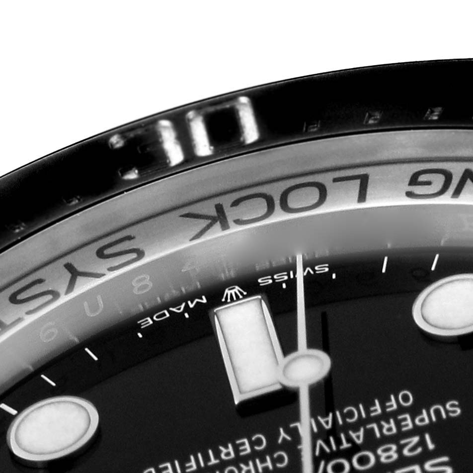 This close-up image of the Rolex Sea-Dweller 126660 Men
s Stainless Steel Black Dial 126660 Men
s Stainless Steel Black Dial watch showcases part of the dial, the "Ring Lock System" text, and the edge of the bezel.