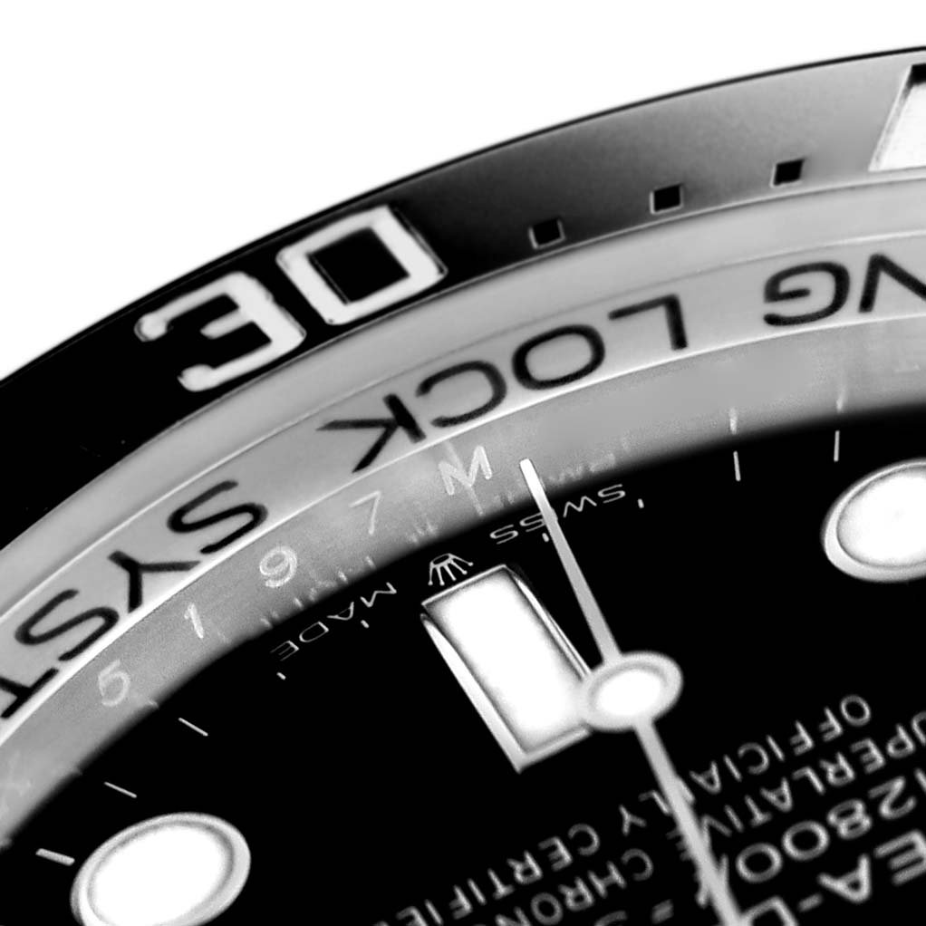 The image shows a close-up of the Rolex Sea-Dweller 136660 Men
s Stainless Steel Black Dial 136660 Men
s Stainless Steel Black Dial watch, highlighting the bezel, part of the dial, and markings.
