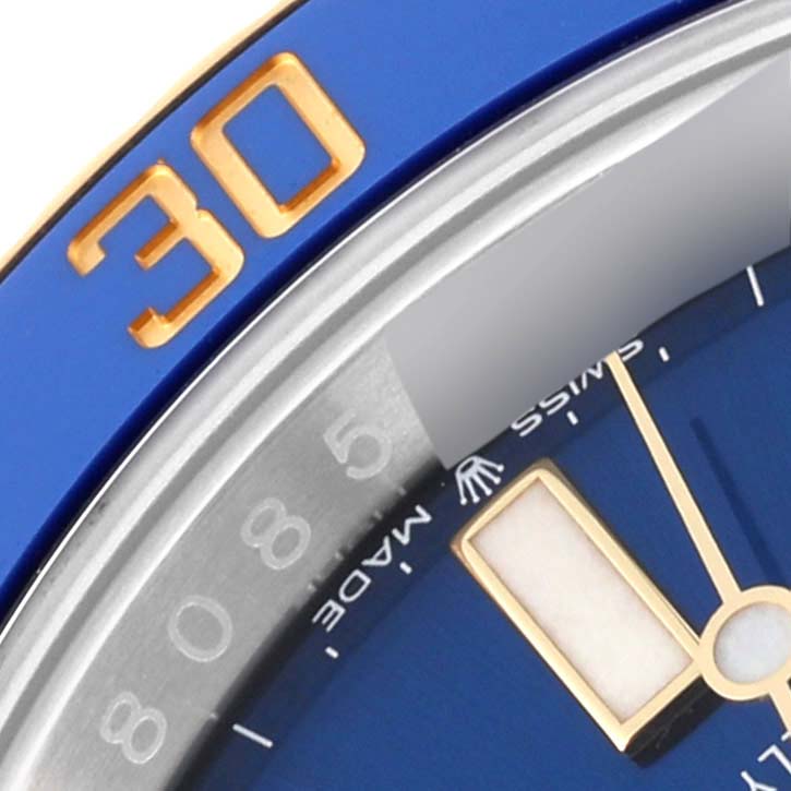 This close-up image shows the blue bezel with a gold "30" and part of the dial of the Rolex Submariner 126613LB Men's Steel and Gold (two tone) Blue Dial 126613LB Men's Steel and Gold (two tone) Blue Dial watch.