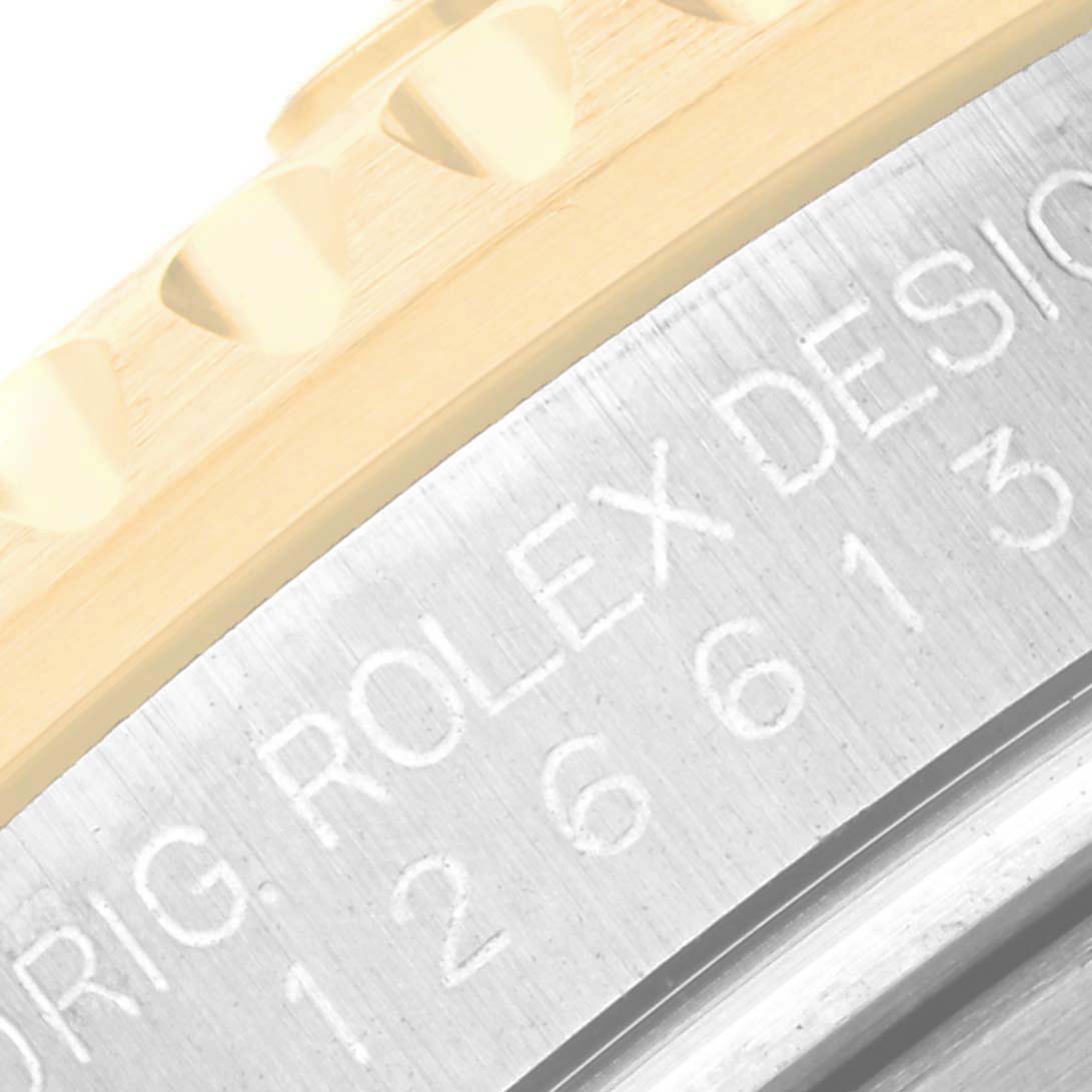 This image shows a close-up of the bezel edge and engraved case of the Rolex Submariner 126613LB Men's Steel and Gold (two tone) Blue Dial 126613LB Men's Steel and Gold (two tone) Blue Dial watch.