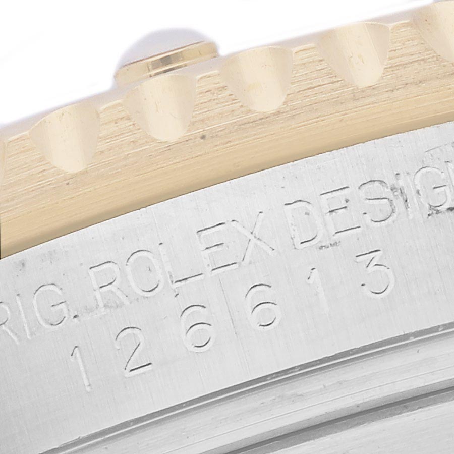 The image shows a close-up of the edge and engraved side of a Rolex Submariner 126613 Men
s Steel and Gold (two tone) Blue Dial 126613 Men
s Steel and Gold (two tone) Blue Dial model, highlighting the bezel and model number.