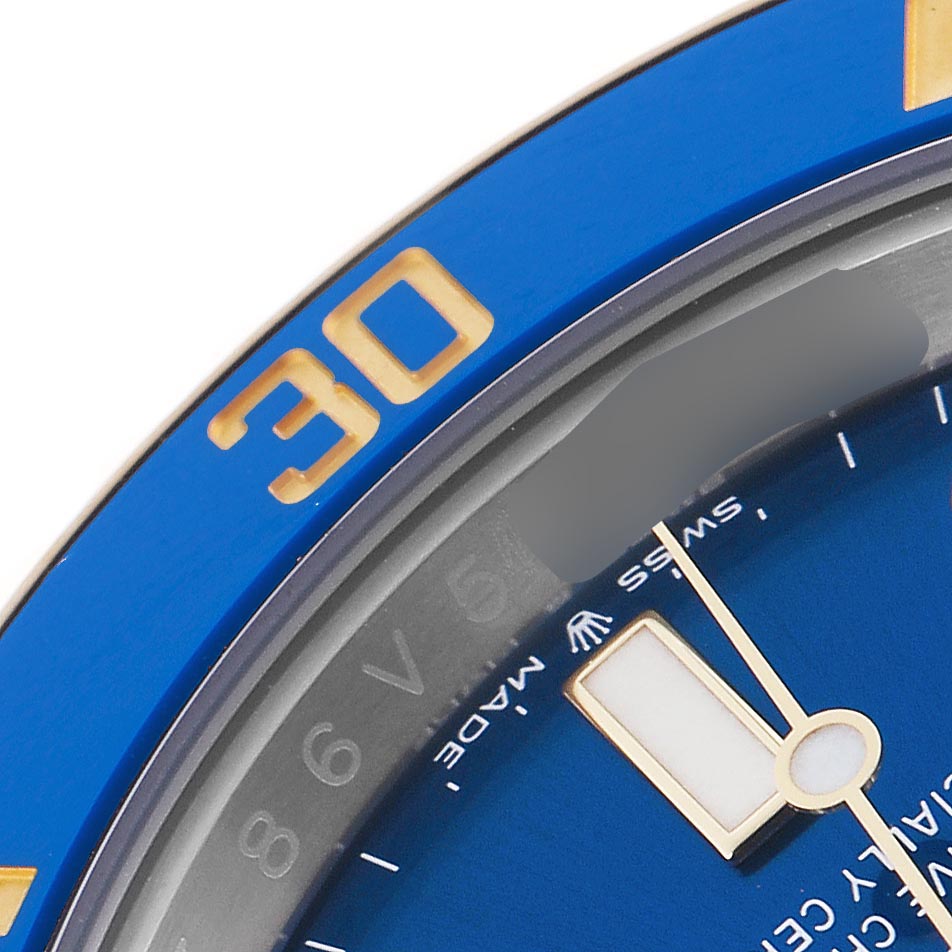 The image shows a close-up of the bezel and dial of a Rolex Submariner 126613 Men
s Steel and Gold (two tone) Blue Dial 126613 Men
s Steel and Gold (two tone) Blue Dial, angled to highlight the numbers and markers.