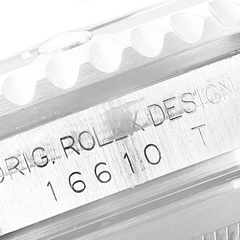 The image shows a close-up view of the model number and part of the bezel of a Rolex Submariner 16610 Men
s Stainless Steel Black Dial 16610 Men
s Stainless Steel Black Dial watch.