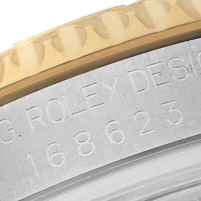The close-up image shows the engravings and part of the bezel of a Rolex Yacht-Master 168623 Men's Steel and Gold (two tone) White Dial 168623 Men's Steel and Gold (two tone) White Dial watch.