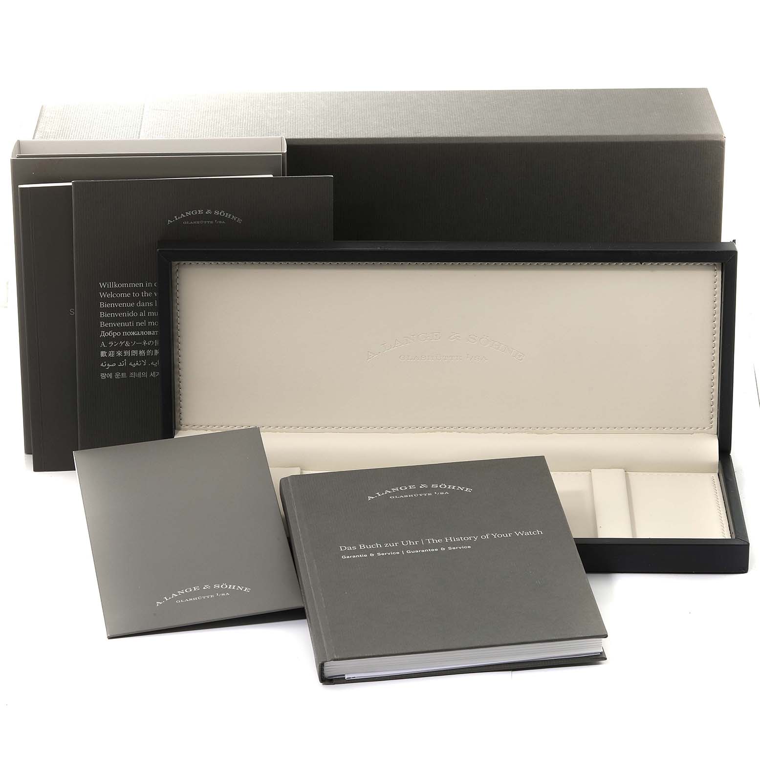 The image displays the packaging and accompanying booklets for the Saxonia watch by A. Lange 
Söhne.
