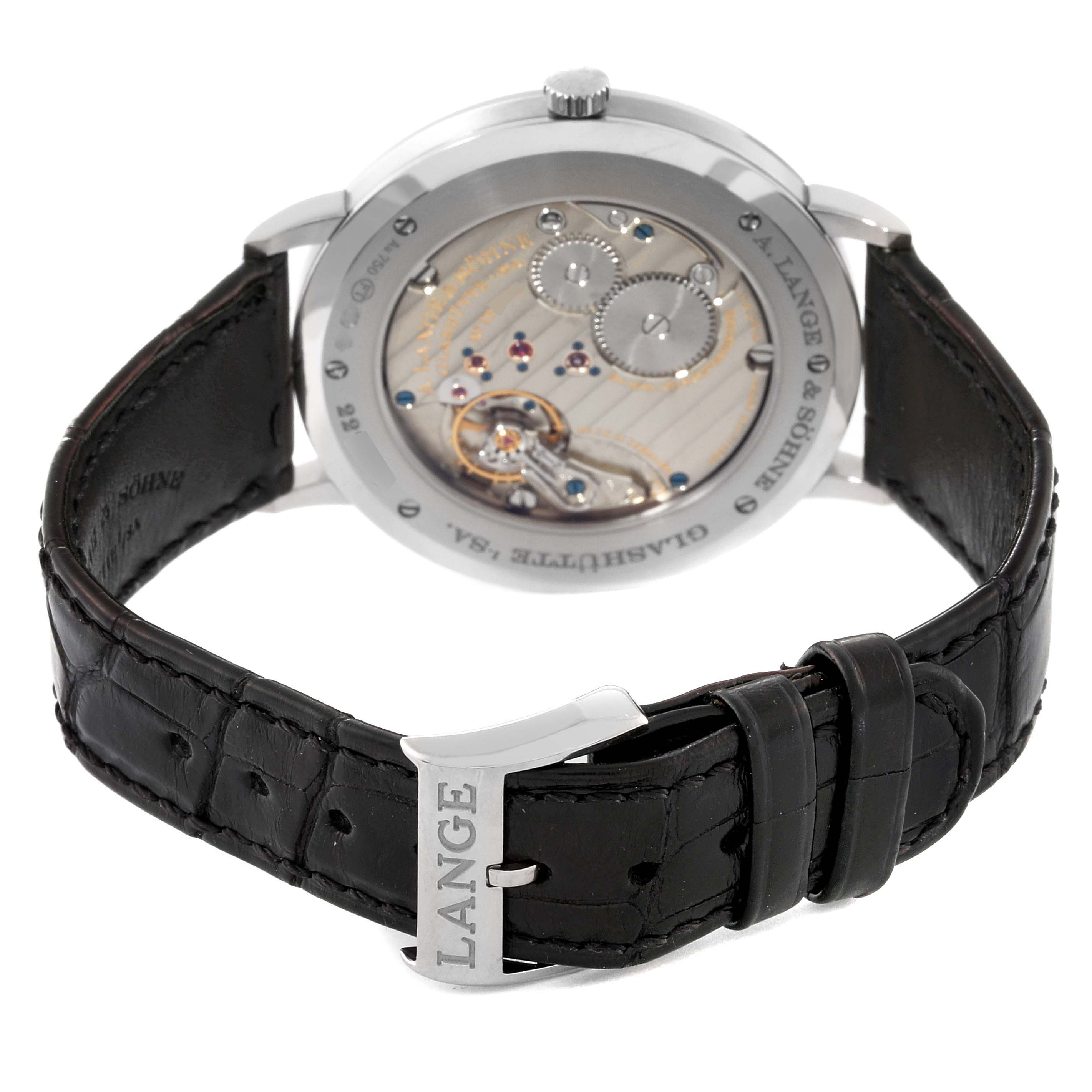 The image shows the Saxonia model by A. Lange 
Sohne from the back, highlighting the movement and the leather strap with "LANGE" on the buckle.