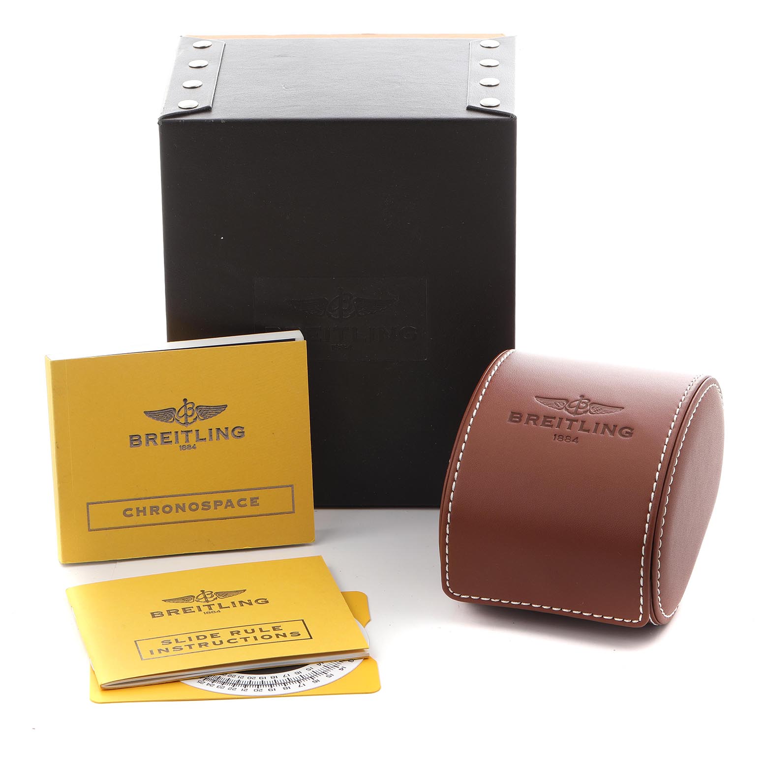 The image shows Breitling Navitimer A35340 Men
s Stainless Steel Blue Dial A35340 Men
s Stainless Steel Blue Dial accessories: a black box, brown case, and booklets seen from an angled view.