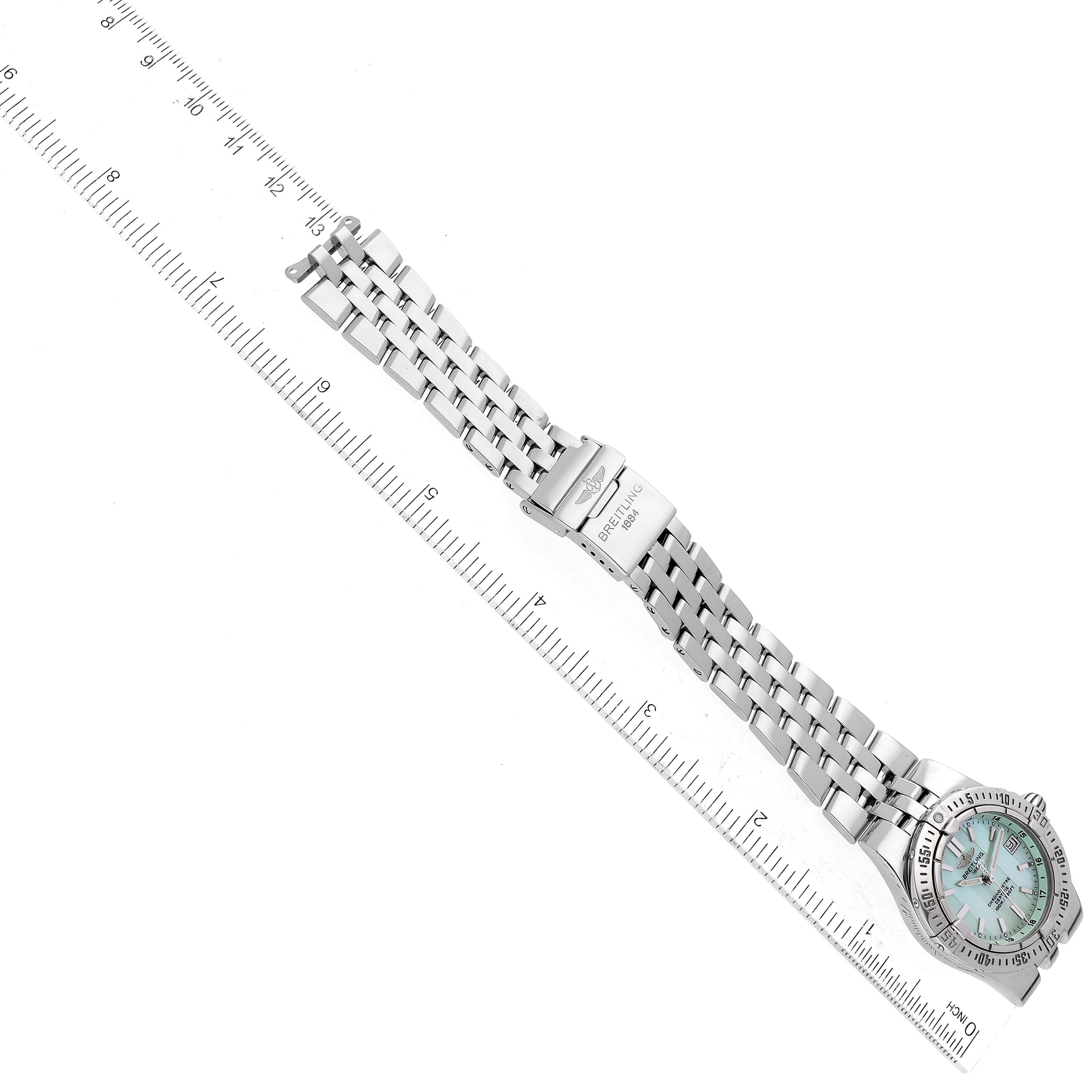 The Starliner Green Mother of Pearl Dial Steel Ladies Watch A71340 by Breitling A71340 Women's Stainless Steel Mother of Pearl Dial A71340 Women's Stainless Steel Mother of Pearl Dial is shown flat and at a slight angle with a ruler beside it.