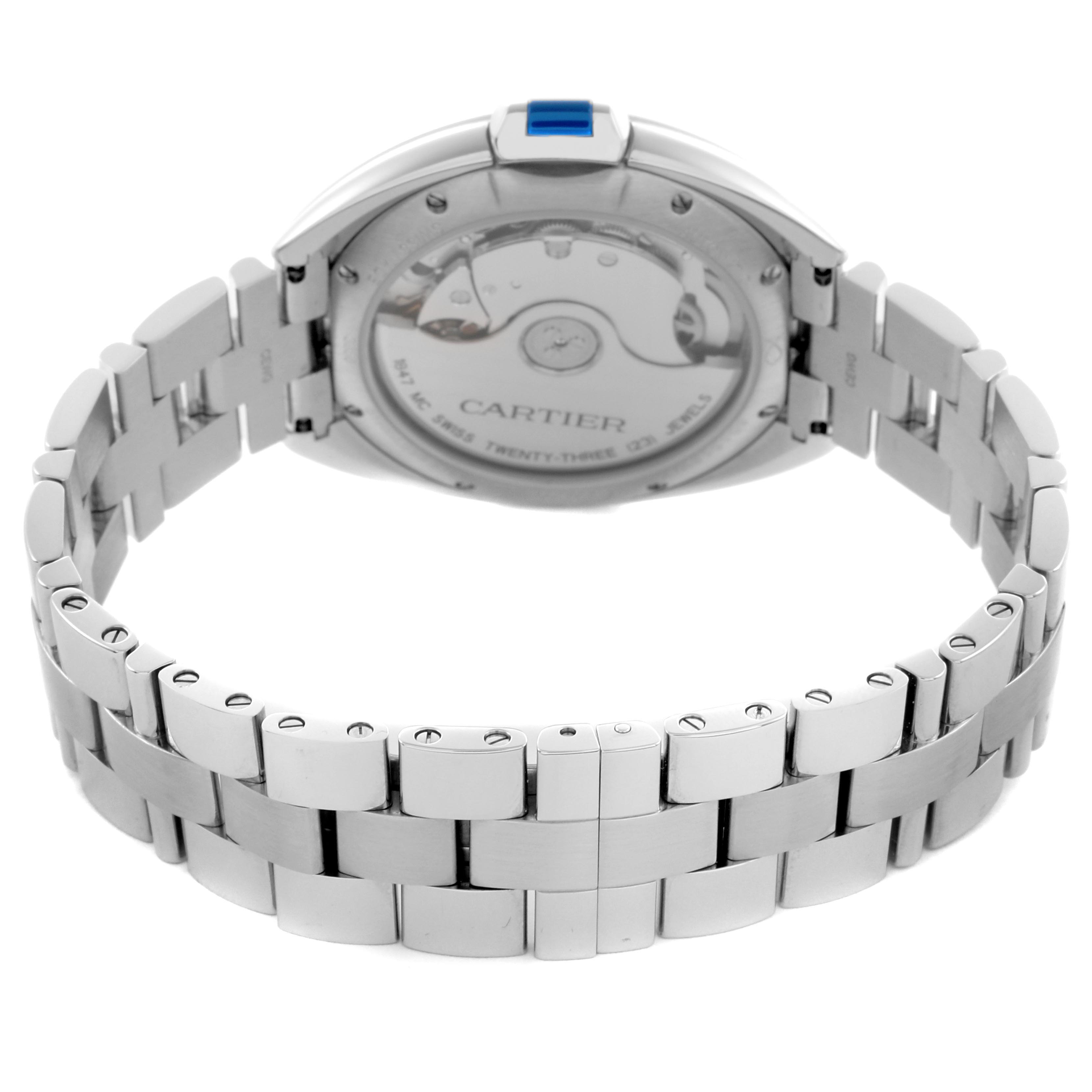 The image shows the back of the Cartier Clé watch, highlighting its stainless steel bracelet and transparent case back.