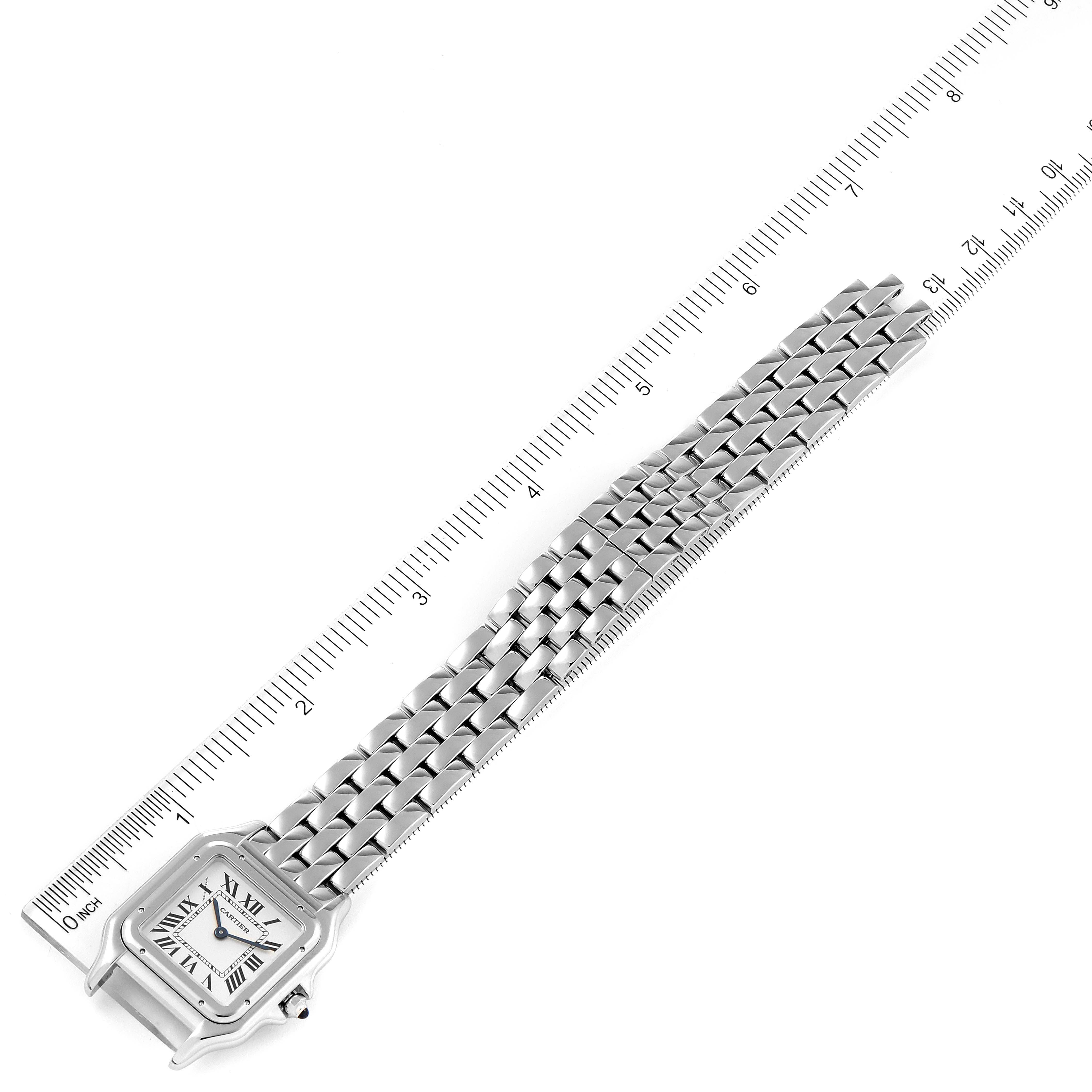 The Cartier Panthere WSPN0007 Women
s Stainless Steel Silver Dial WSPN0007 Women
s Stainless Steel Silver Dial watch is shown from a top-down angle, showcasing the face and the full bracelet alongside a ruler.