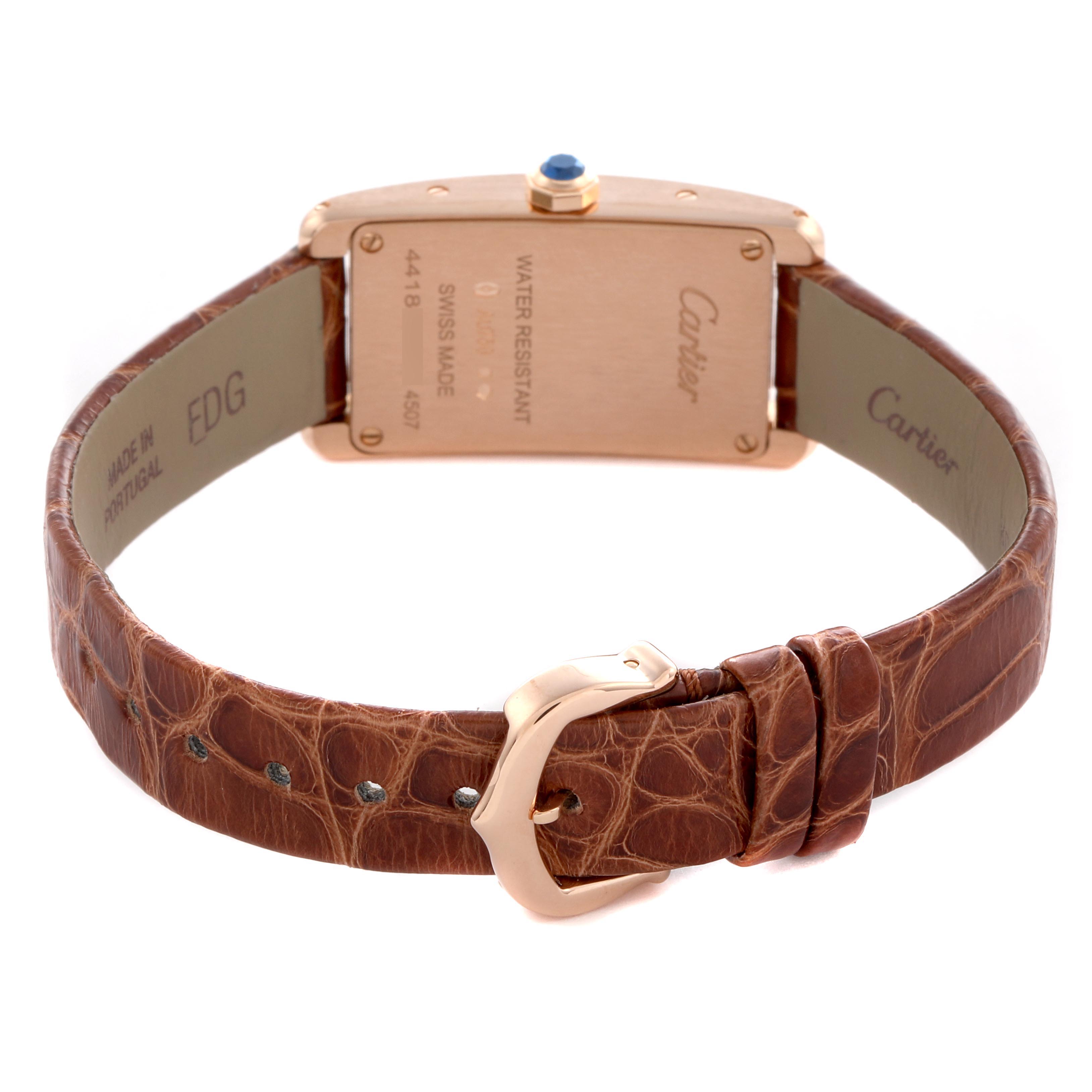 The Cartier Tank Americaine W2607456 Women
s Rose Gold Silver Dial W2607456 Women
s Rose Gold Silver Dial watch is shown from the back, displaying the case back, crown, and leather strap with buckle.