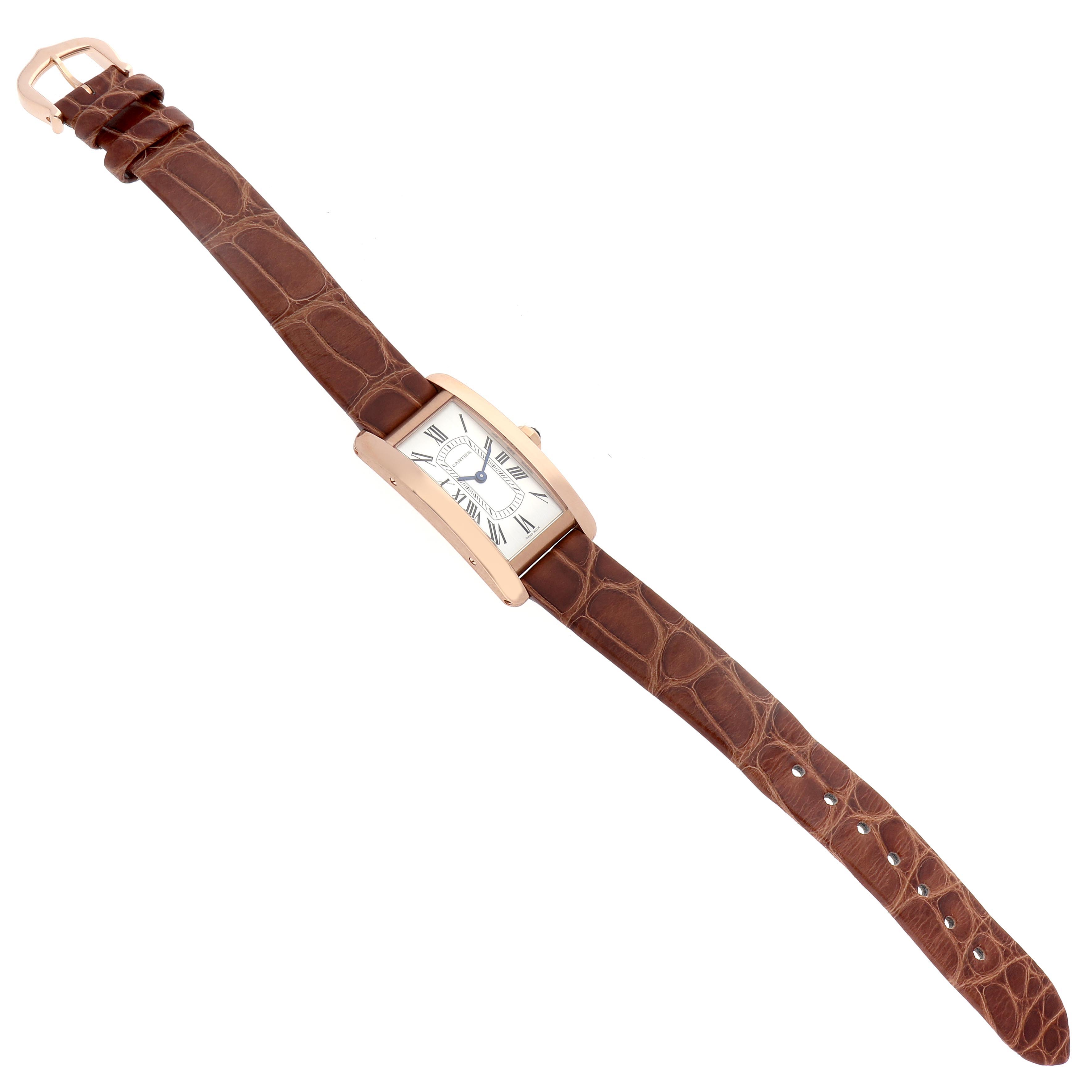 The Cartier Tank Americaine W2607456 Women
s Rose Gold Silver Dial W2607456 Women
s Rose Gold Silver Dial watch is shown at an angled top view, displaying its face, brown leather strap, and gold buckle.