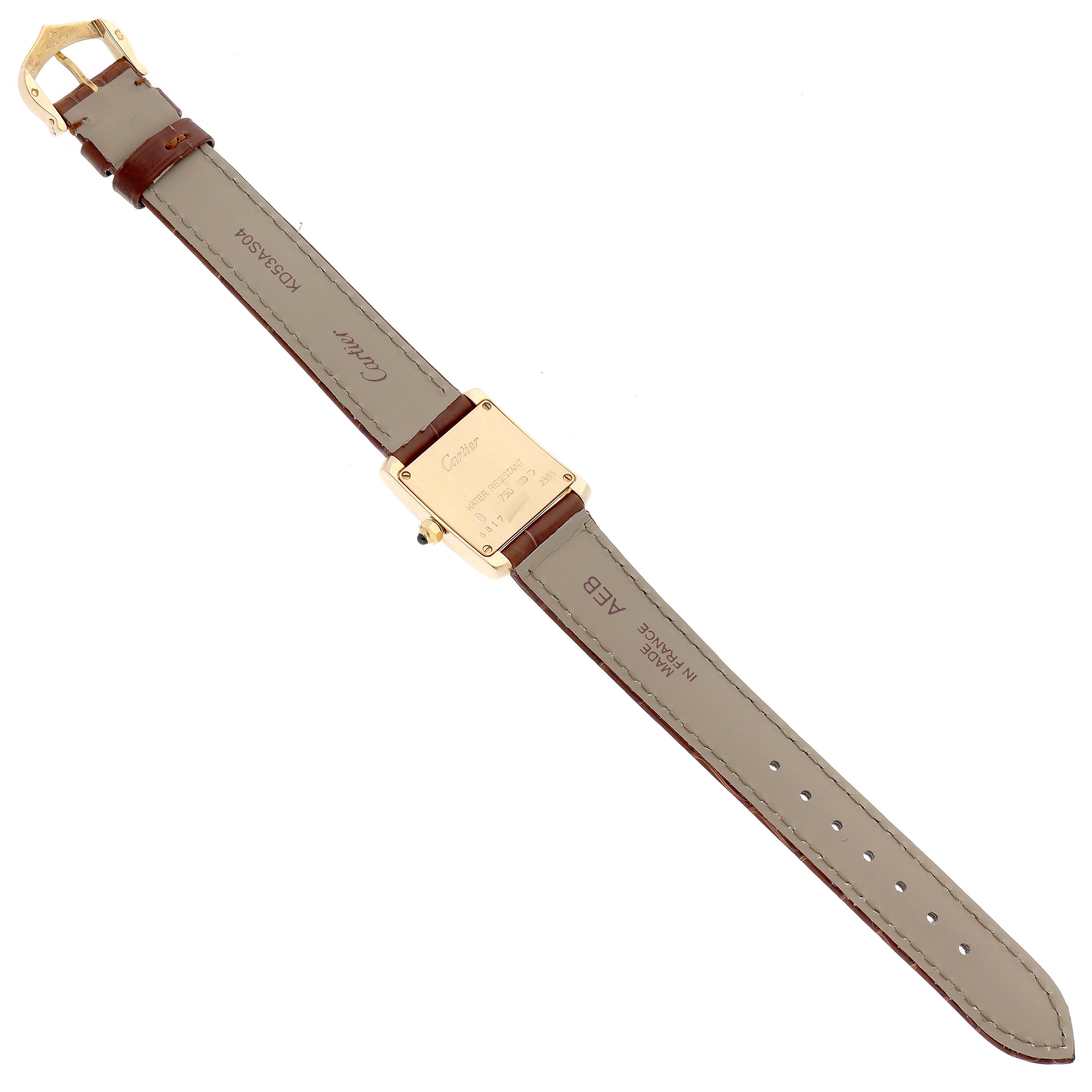 The image shows the back view of a Cartier Tank Française watch, including the leather strap and clasp.