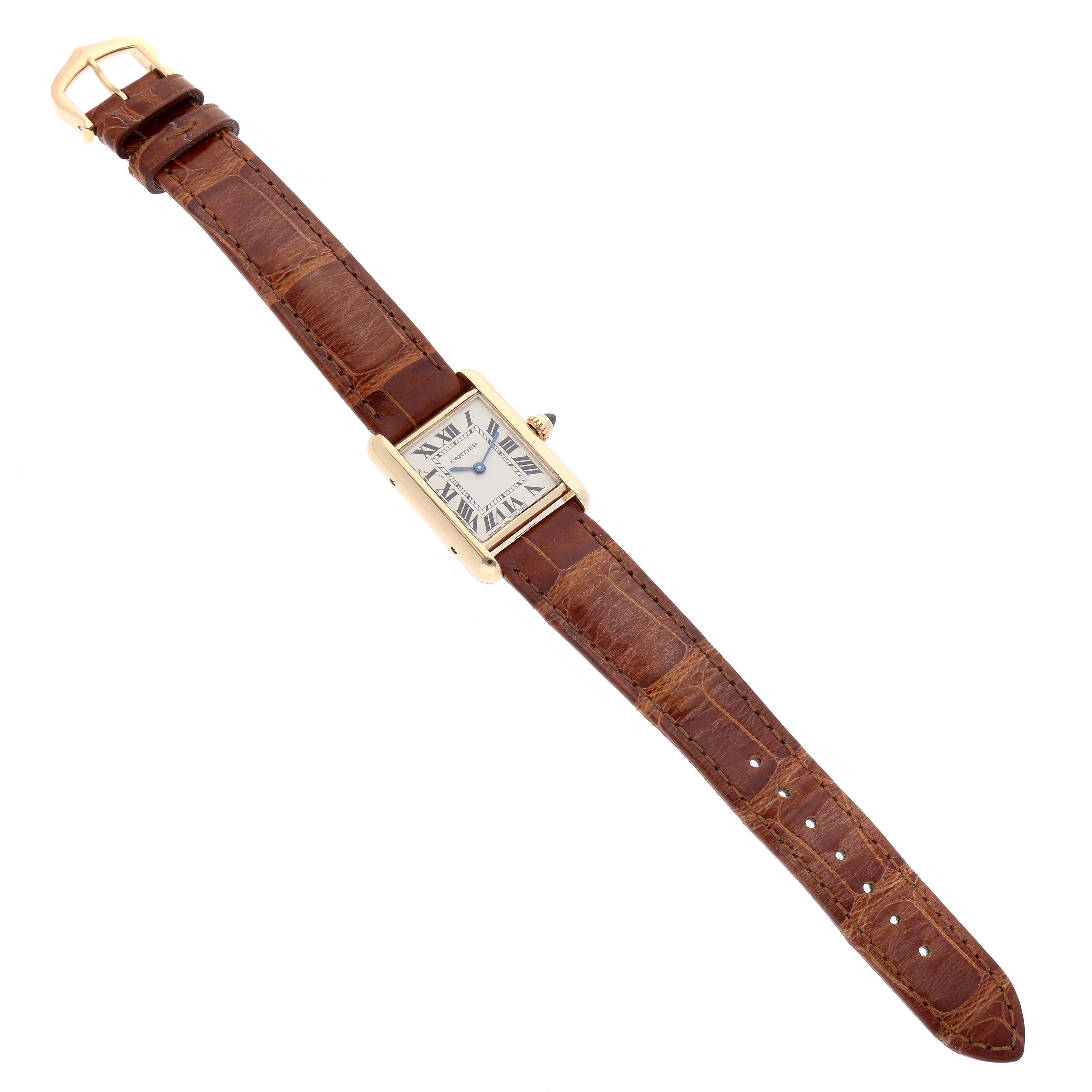 The image shows a top-down view of a Cartier Tank Louis W1529856 Women's Yellow Gold Silver Dial W1529856 Women's Yellow Gold Silver Dial watch featuring its face, dial, crown, and leather strap.