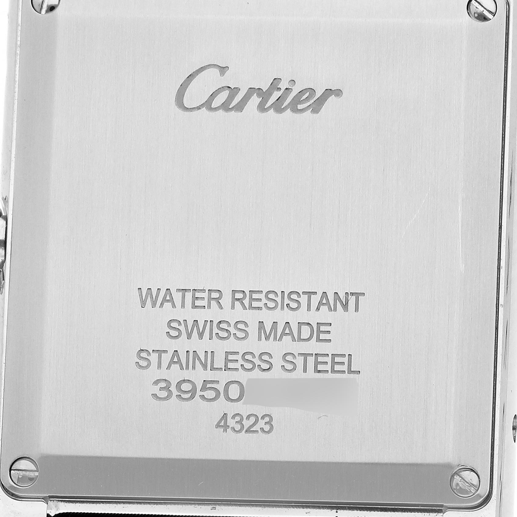 The image shows the back case of a Cartier Tank Must W4TA0017 Women
s Stainless Steel Silver Dial W4TA0017 Women
s Stainless Steel Silver Dial watch, featuring engraved brand details and specifications.