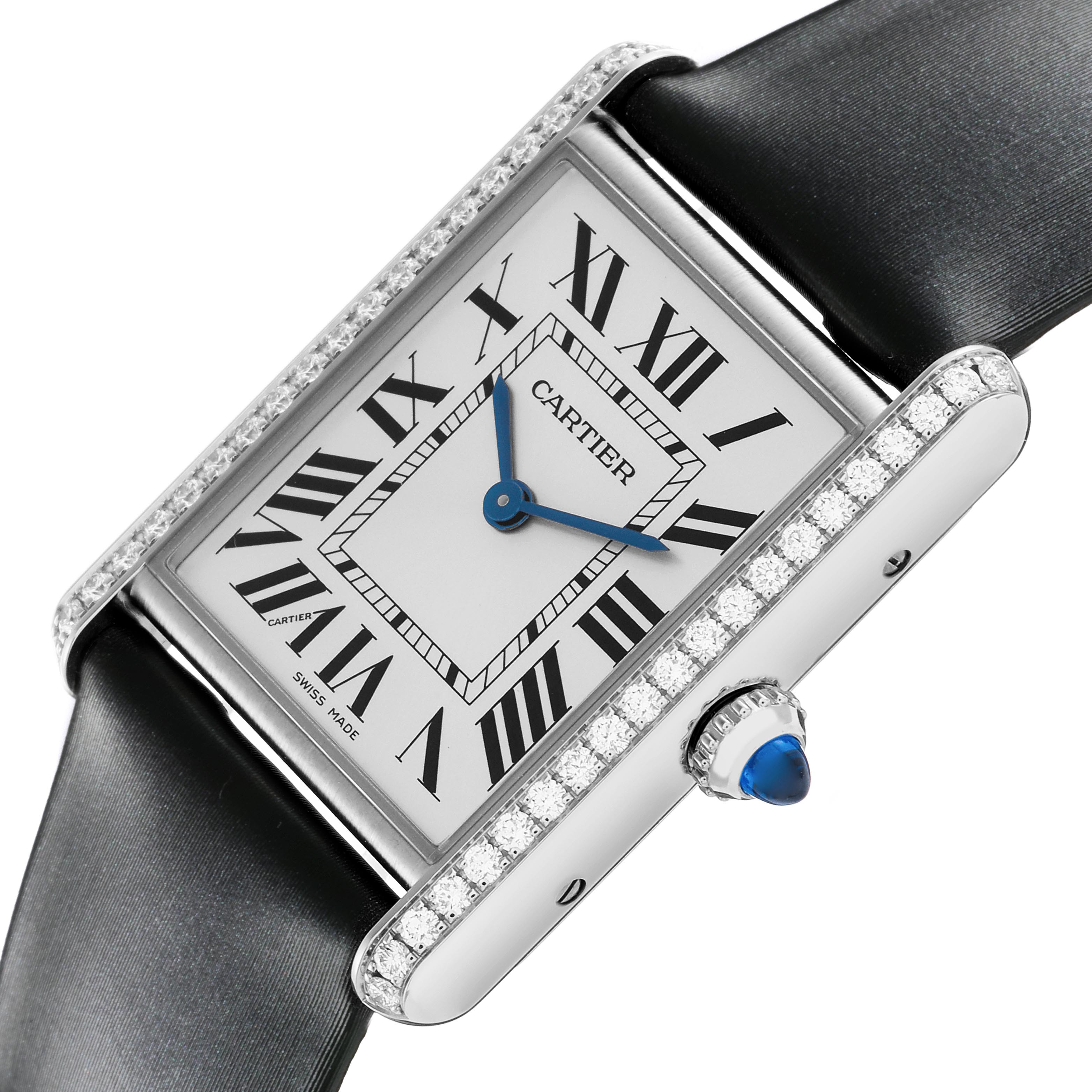The Cartier Tank Must W4TA0017 Women
s Stainless Steel Silver Dial W4TA0017 Women
s Stainless Steel Silver Dial watch is shown from a close-up angle, highlighting the face, bezel with diamonds, and a blue cabochon crown.