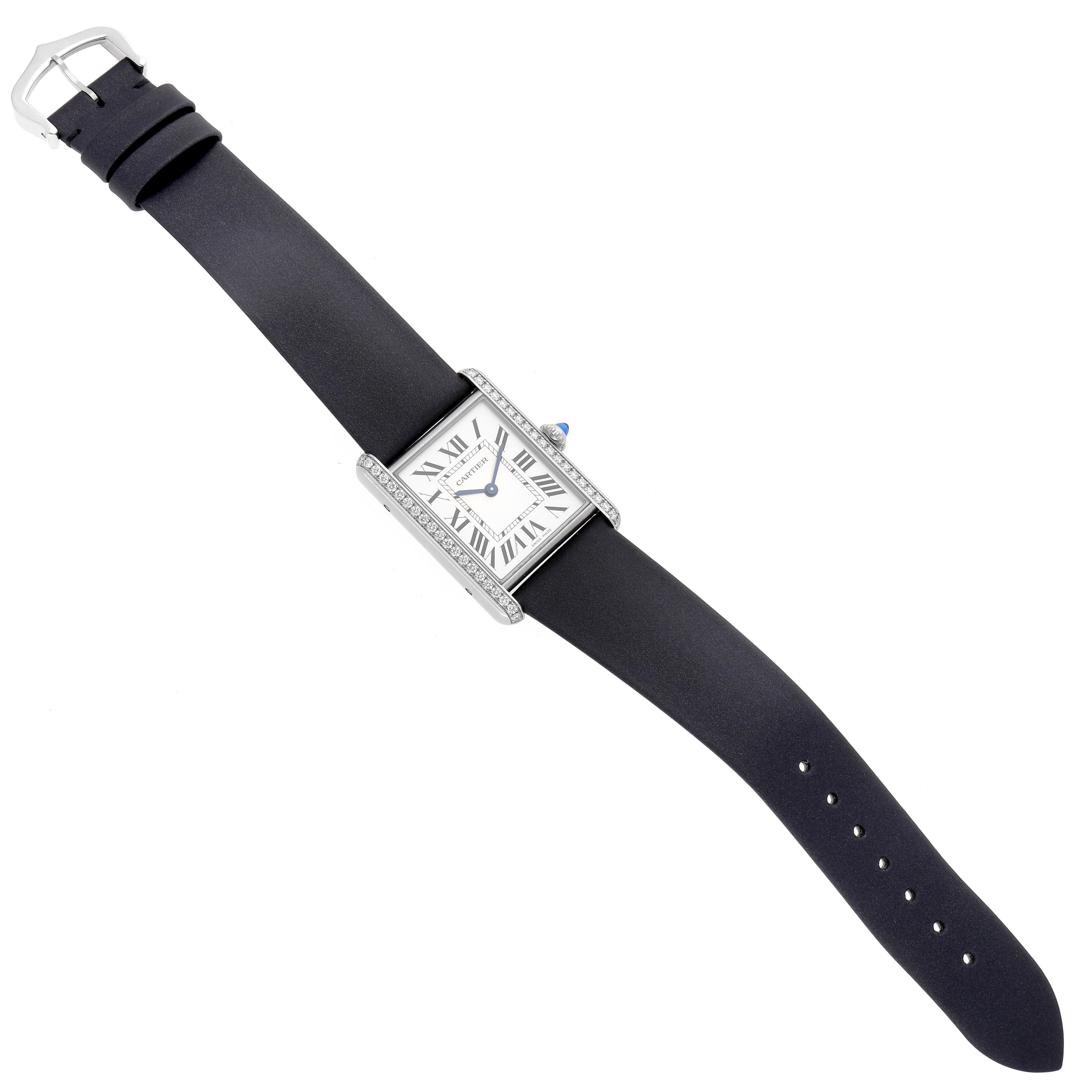 The Cartier Tank Must W4TA0017 Women
s Stainless Steel Silver Dial W4TA0017 Women
s Stainless Steel Silver Dial watch is shown from a top-down angle, displaying the face, bezel, and black leather strap.