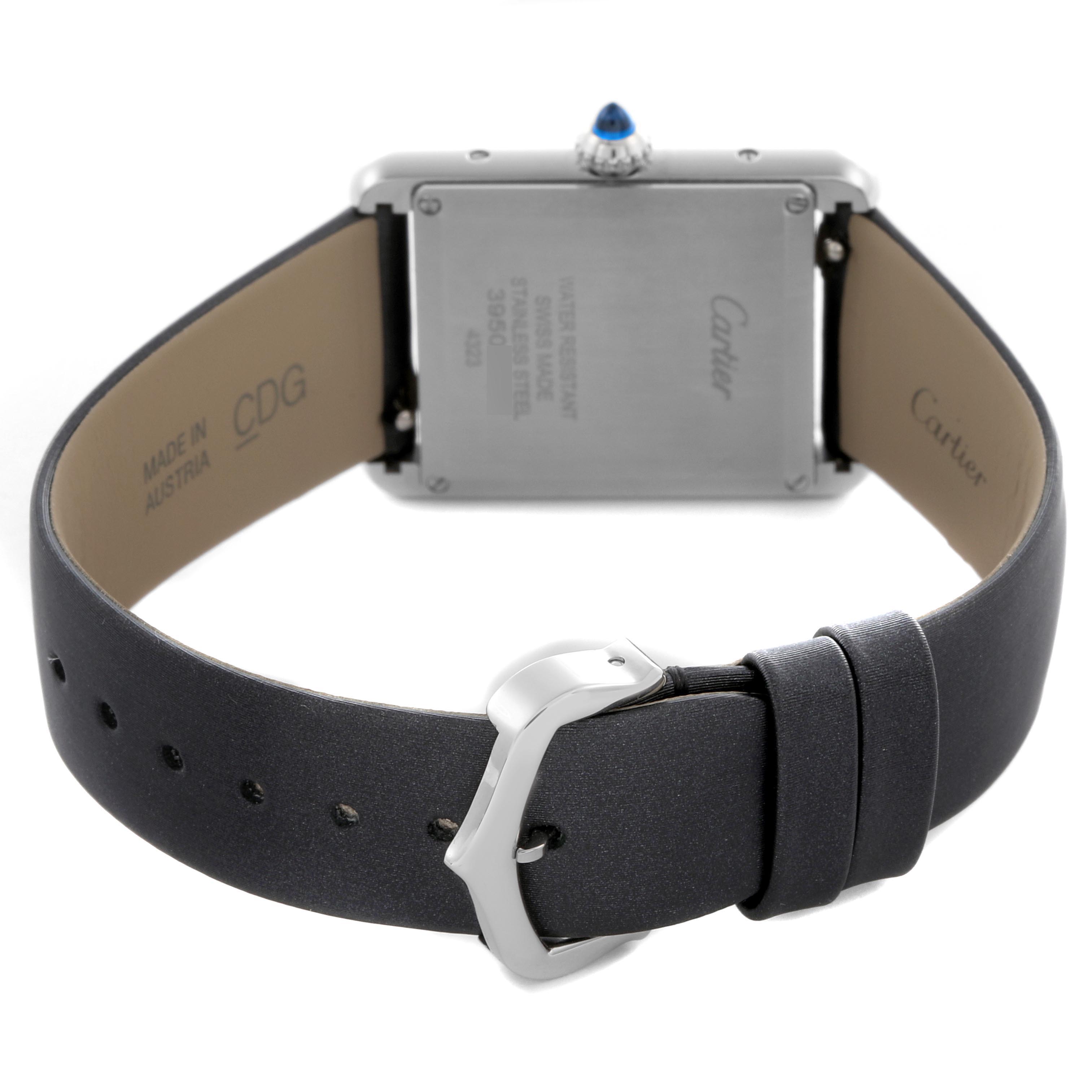 The image shows the back of the Cartier Tank Must W4TA0017 Women
s Stainless Steel Silver Dial W4TA0017 Women
s Stainless Steel Silver Dial watch, focusing on the clasp, case back, and crown.