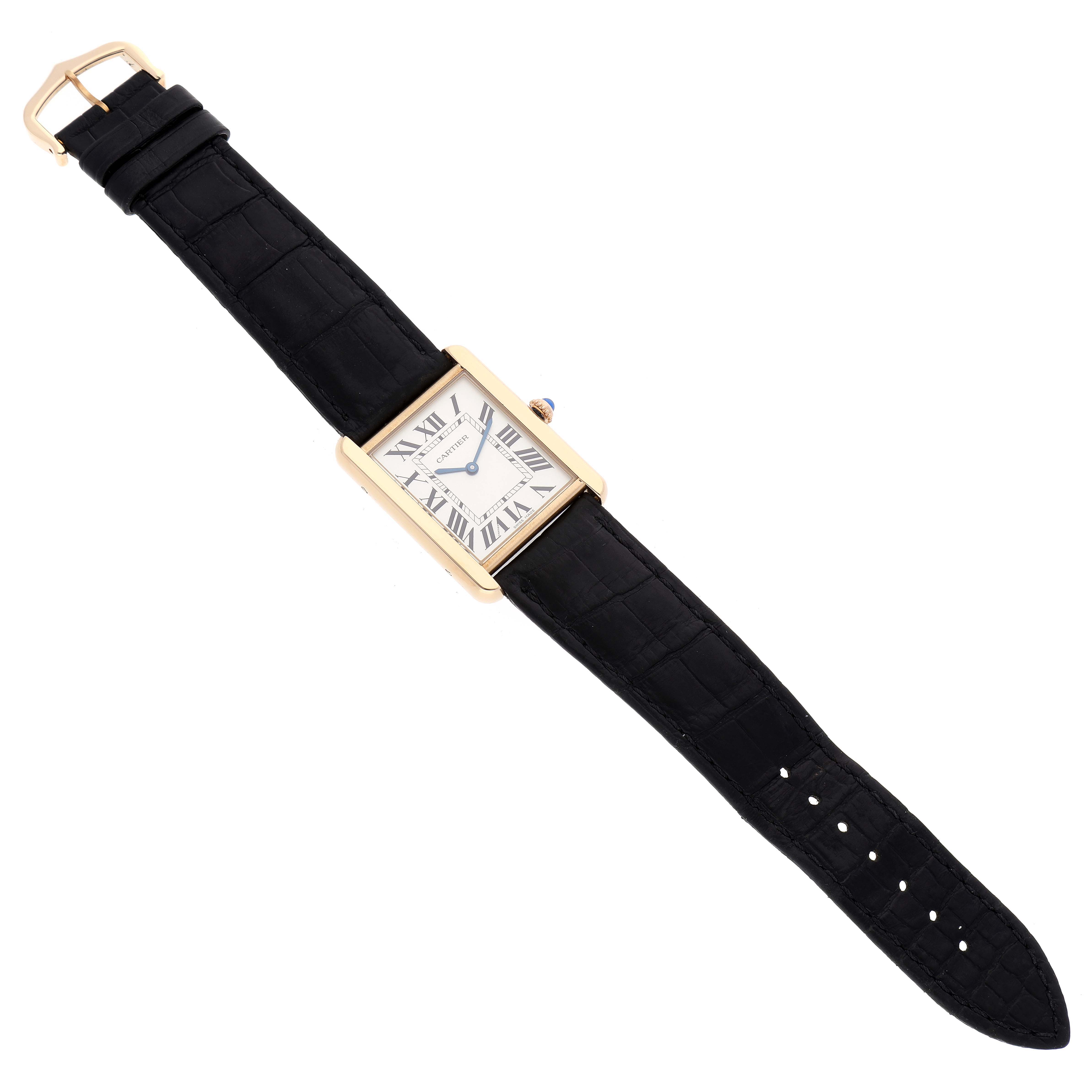 The image shows a Cartier Tank Solo W5200004 Men
s Yellow Gold Silver Dial W5200004 Men
s Yellow Gold Silver Dial watch from a top-down angle, displaying the full strap and rectangular face.