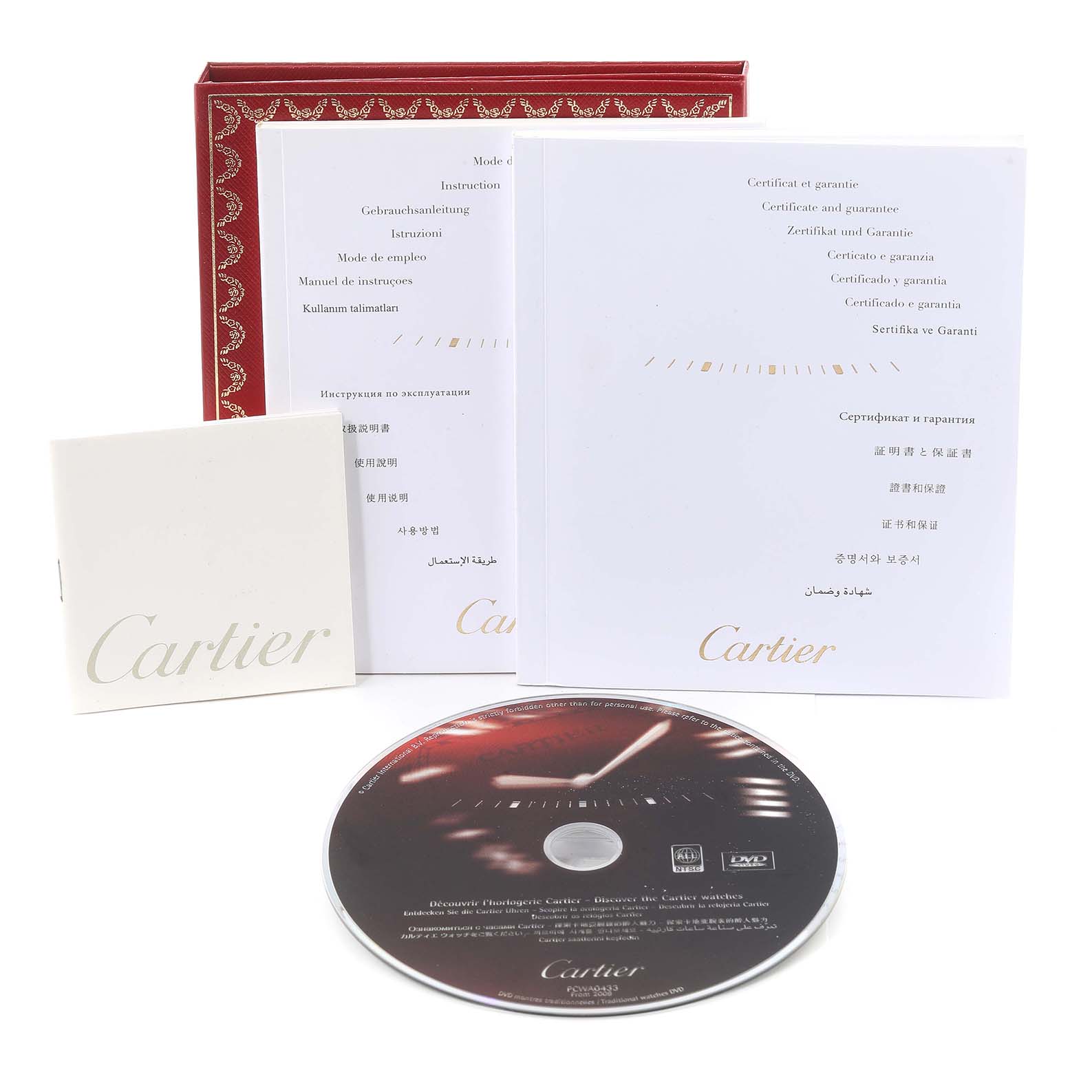 The image shows the manual, certificate of warranty, a booklet, and a DVD for the Cartier Tank Solo W5200004 Men
s Yellow Gold Silver Dial W5200004 Men
s Yellow Gold Silver Dial watch, along with a box lid.