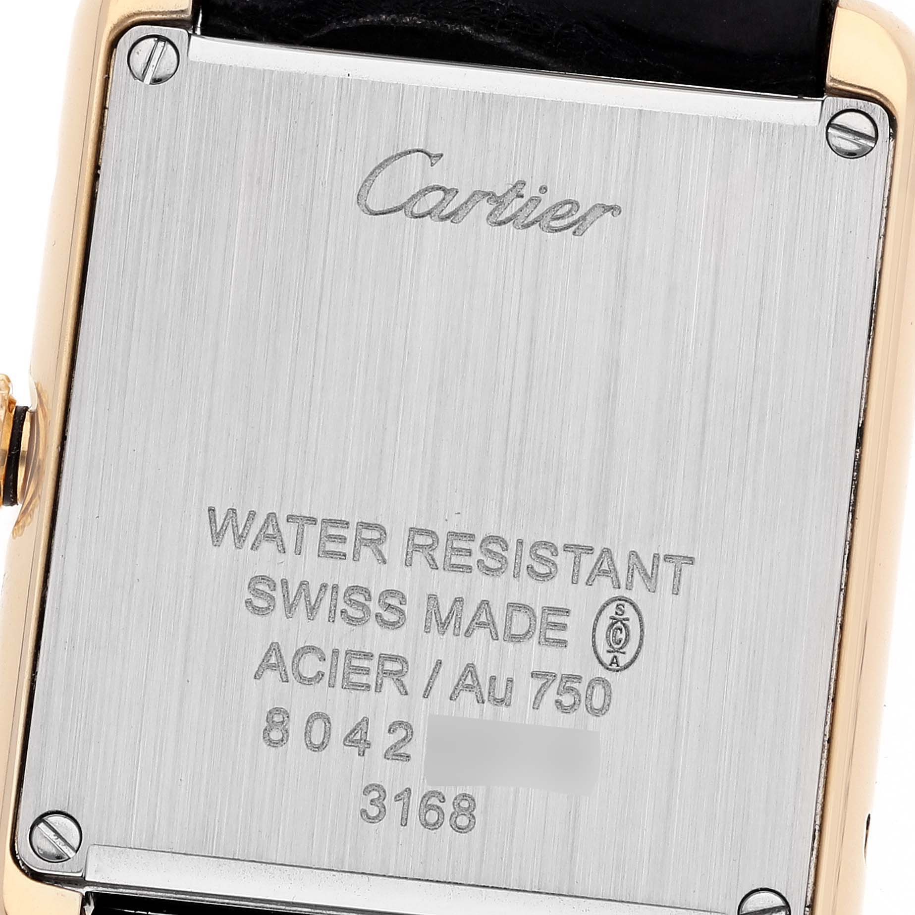 The image shows the back case of a Cartier Tank Solo W5200002 Women's Yellow Gold Silver Dial W5200002 Women's Yellow Gold Silver Dial watch, including inscriptions and screws at the corners.