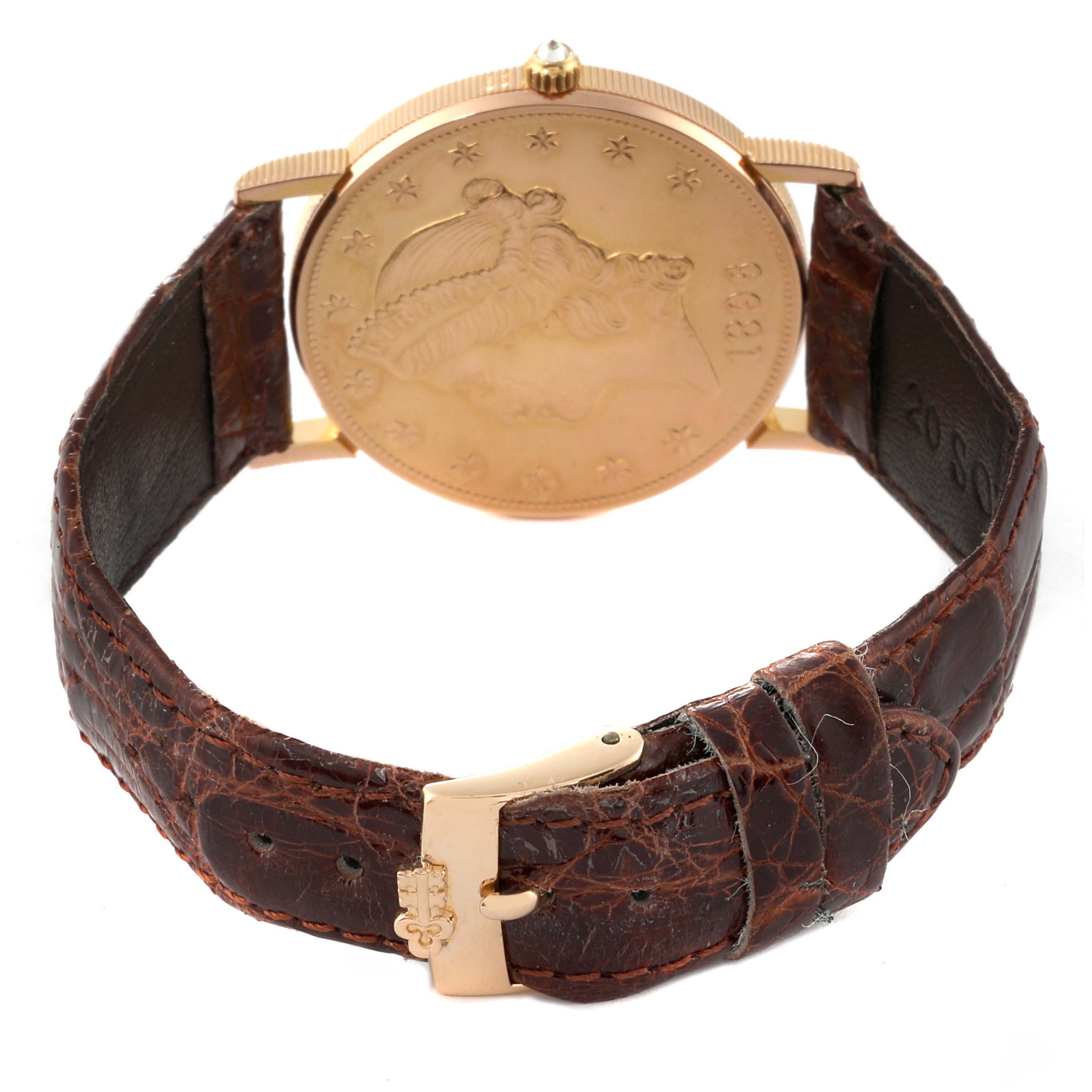 The Corum Coin Watch 1896 Men's Yellow Gold Champagne Dial 1896 Men's Yellow Gold Champagne Dial model is shown from the back, displaying its coin design and leather strap with a gold clasp.