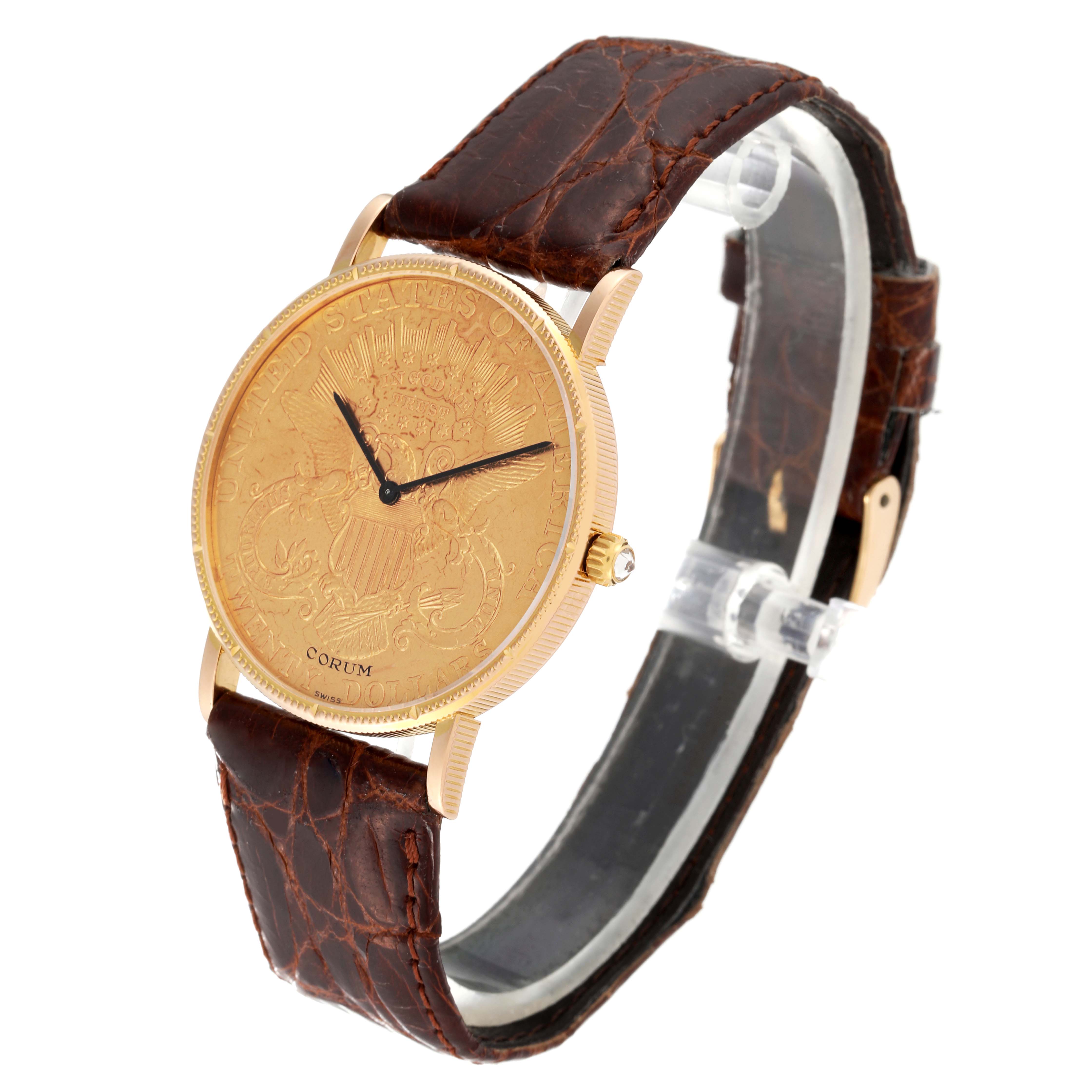 The Corum Coin Watch 1896 Men's Yellow Gold Champagne Dial 1896 Men's Yellow Gold Champagne Dial model is shown from a three-quarters angle, displaying the watch face, crown, and brown leather strap.