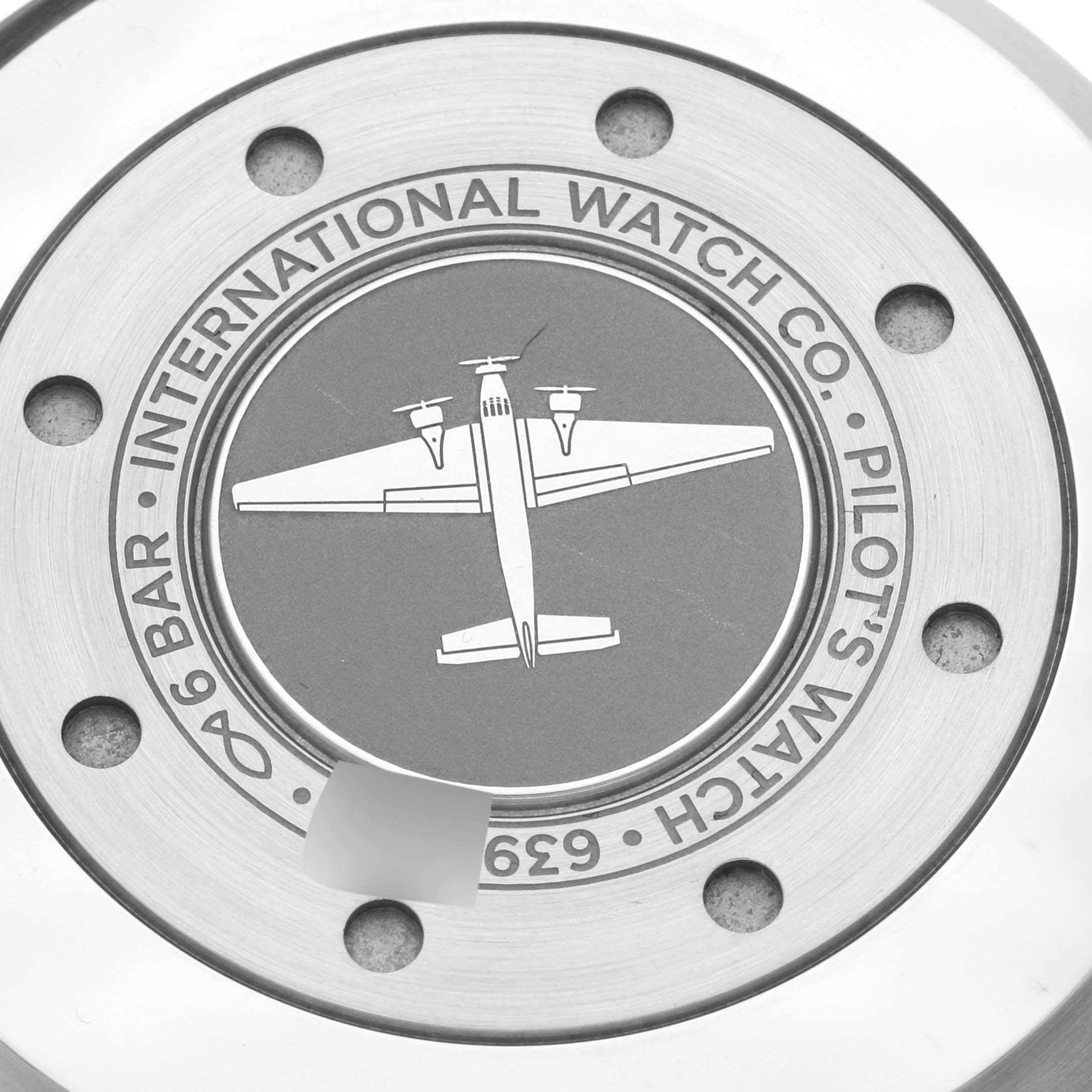 This image shows the back case of the IWC Pilot IW501001 Men
s Stainless Steel Black Dial IW501001 Men
s Stainless Steel Black Dial model watch, featuring an airplane engraving.