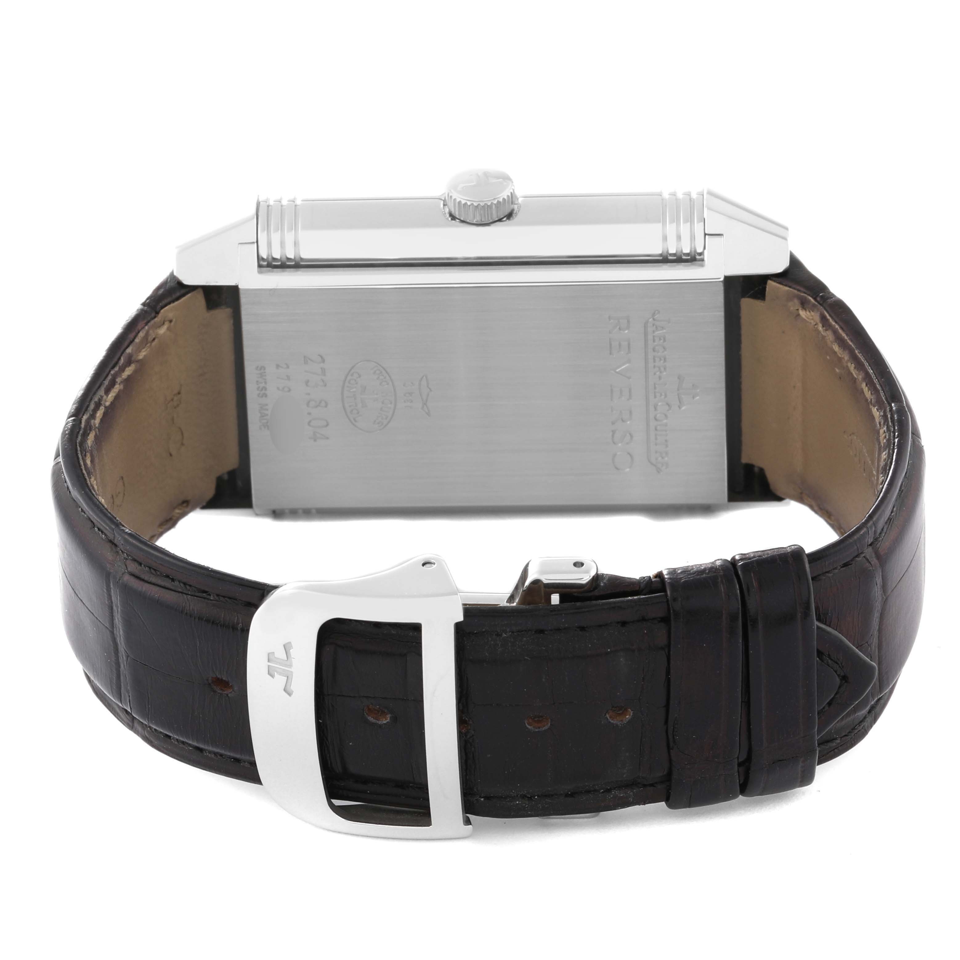 The image shows the back view of a Jaeger LeCoultre Reverso Q3738420 Men
s Stainless Steel Silver Dial Q3738420 Men
s Stainless Steel Silver Dial watch, highlighting its clasp, leather strap, and case.