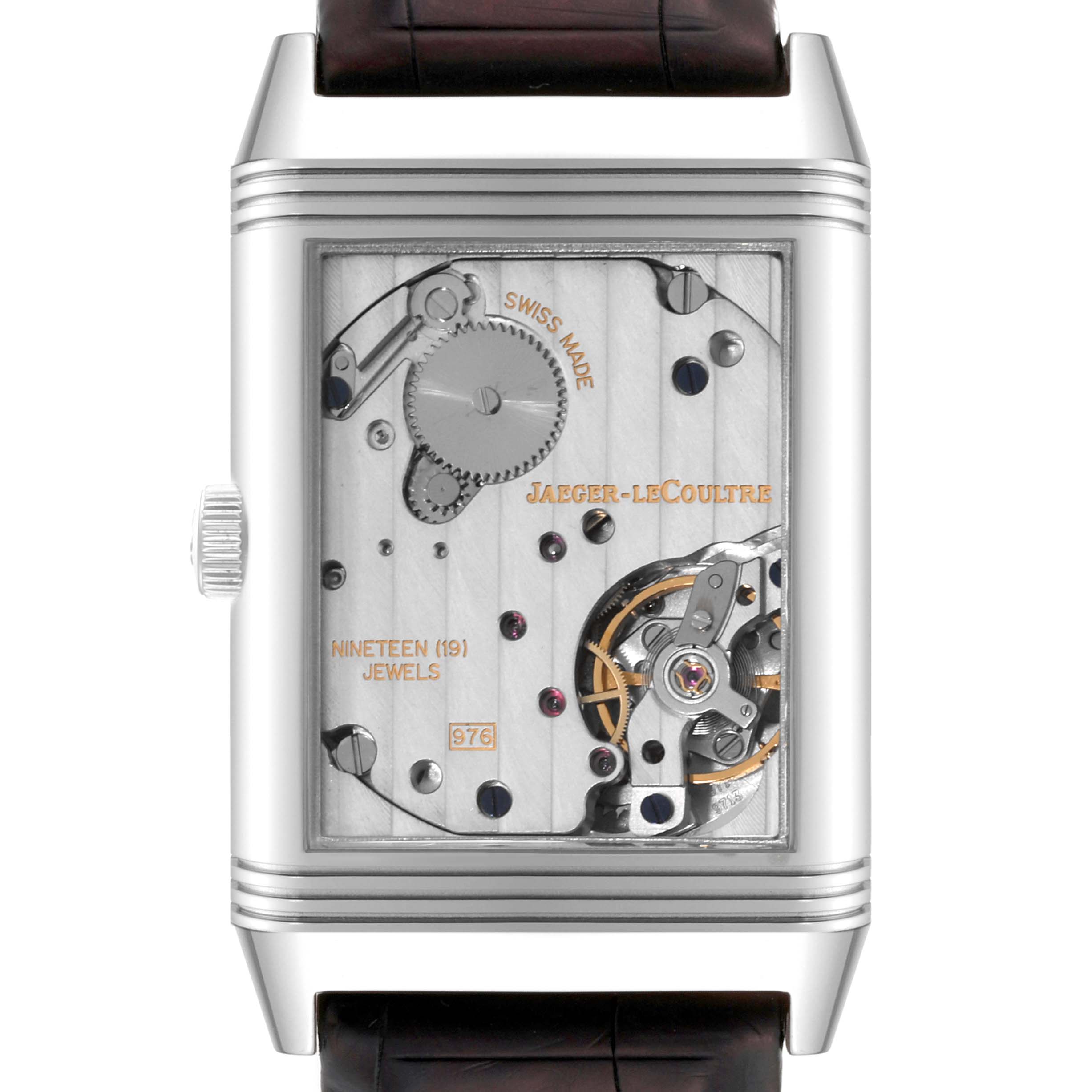 The image shows the back view of the Jaeger-LeCoultre Reverso watch, revealing its mechanical movement.