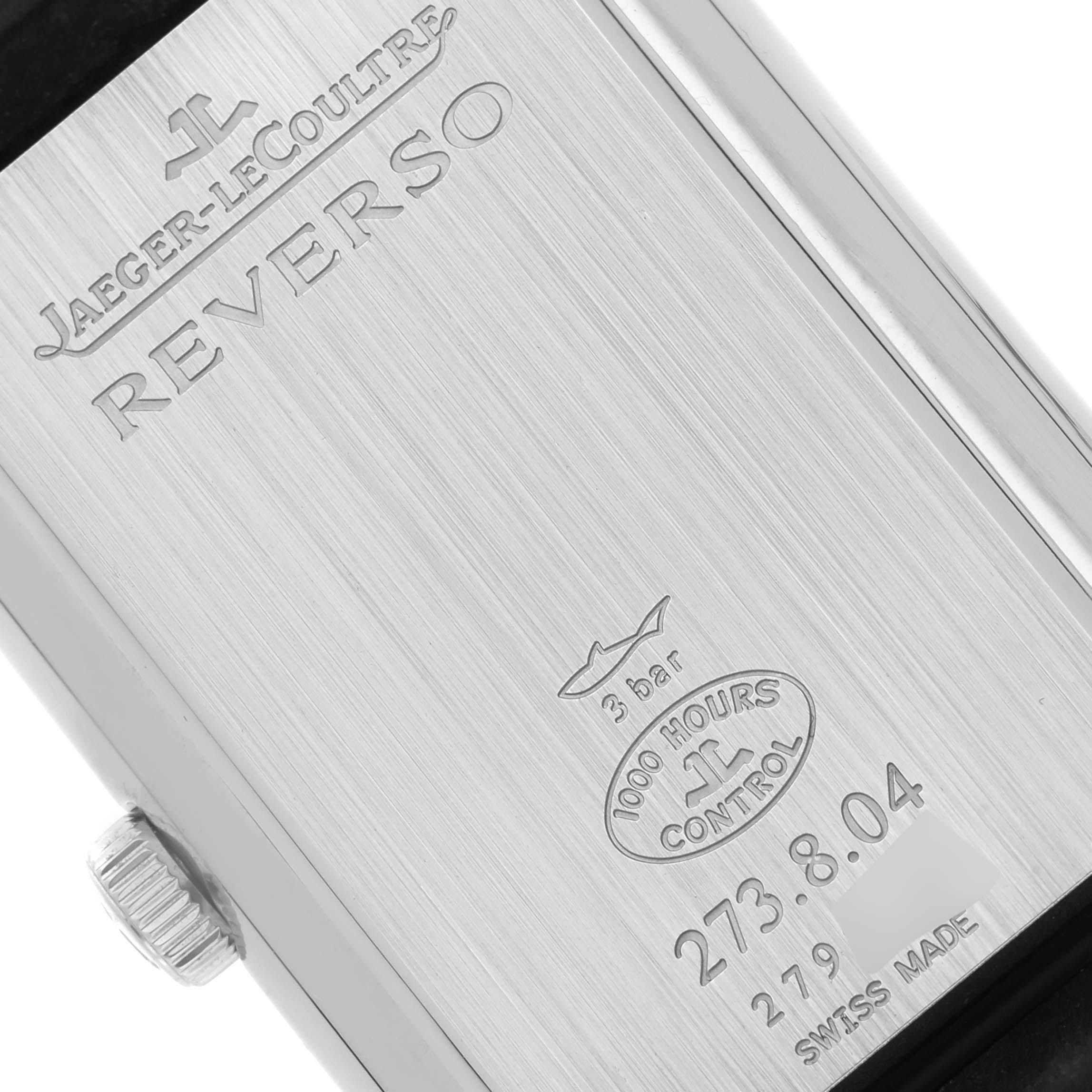 The image shows the back casing of a Jaeger-LeCoultre Reverso watch, highlighting brand engravings and the model number.