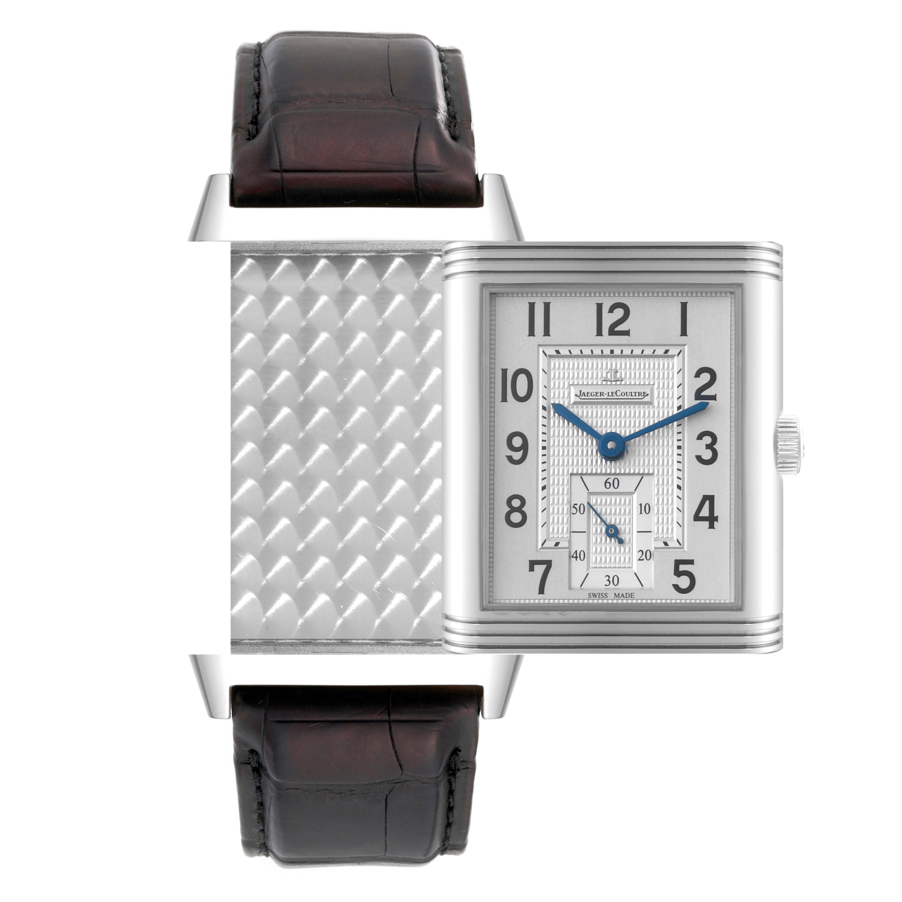 The image displays a Jaeger LeCoultre Reverso Q3738420 Men
s Stainless Steel Silver Dial Q3738420 Men
s Stainless Steel Silver Dial watch face and partially reversed case, with its strap shown from a top-down angle.