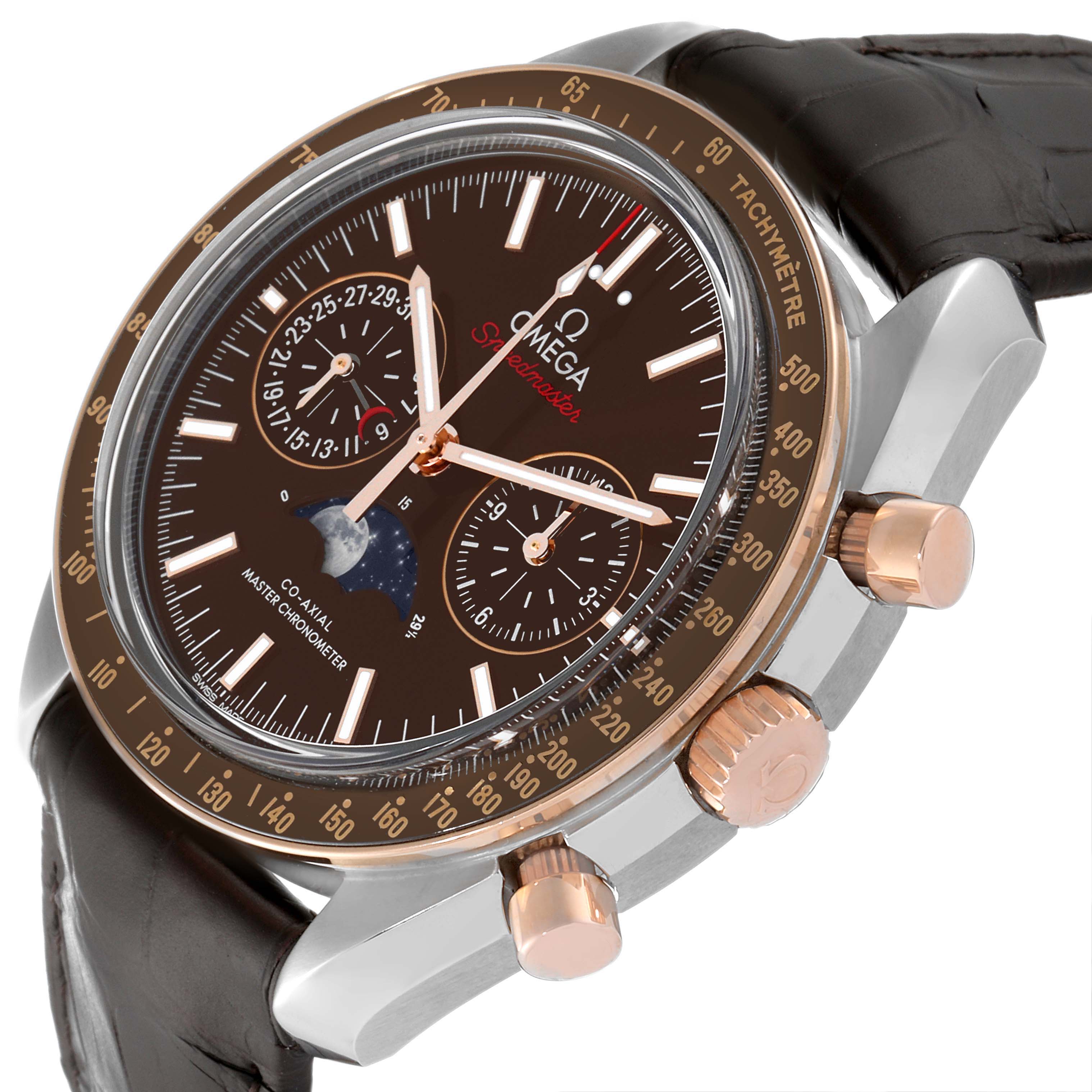 The Omega Speedmaster 304.23.44.52.13.001 Men's Steel and Gold (two tone) Brown Dial 304.23.44.52.13.001 Men's Steel and Gold (two tone) Brown Dial watch is shown at an angled view highlighting the face, bezel, crown, pushers, and leather strap.
