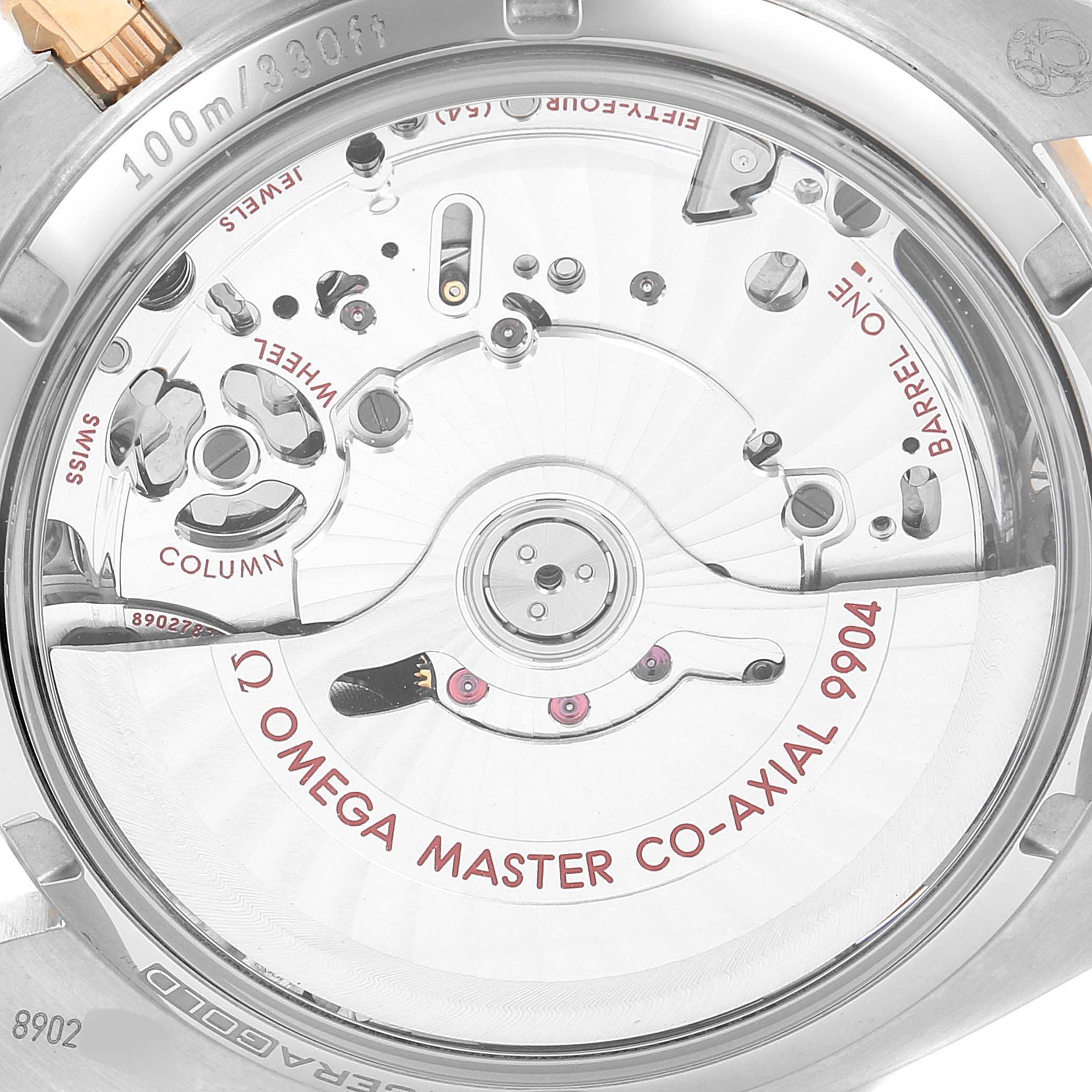 The image shows the back of an Omega Speedmaster 304.23.44.52.13.001 Men's Steel and Gold (two tone) Brown Dial 304.23.44.52.13.001 Men's Steel and Gold (two tone) Brown Dial, highlighting the Omega Master Co-Axial 9904 movement.