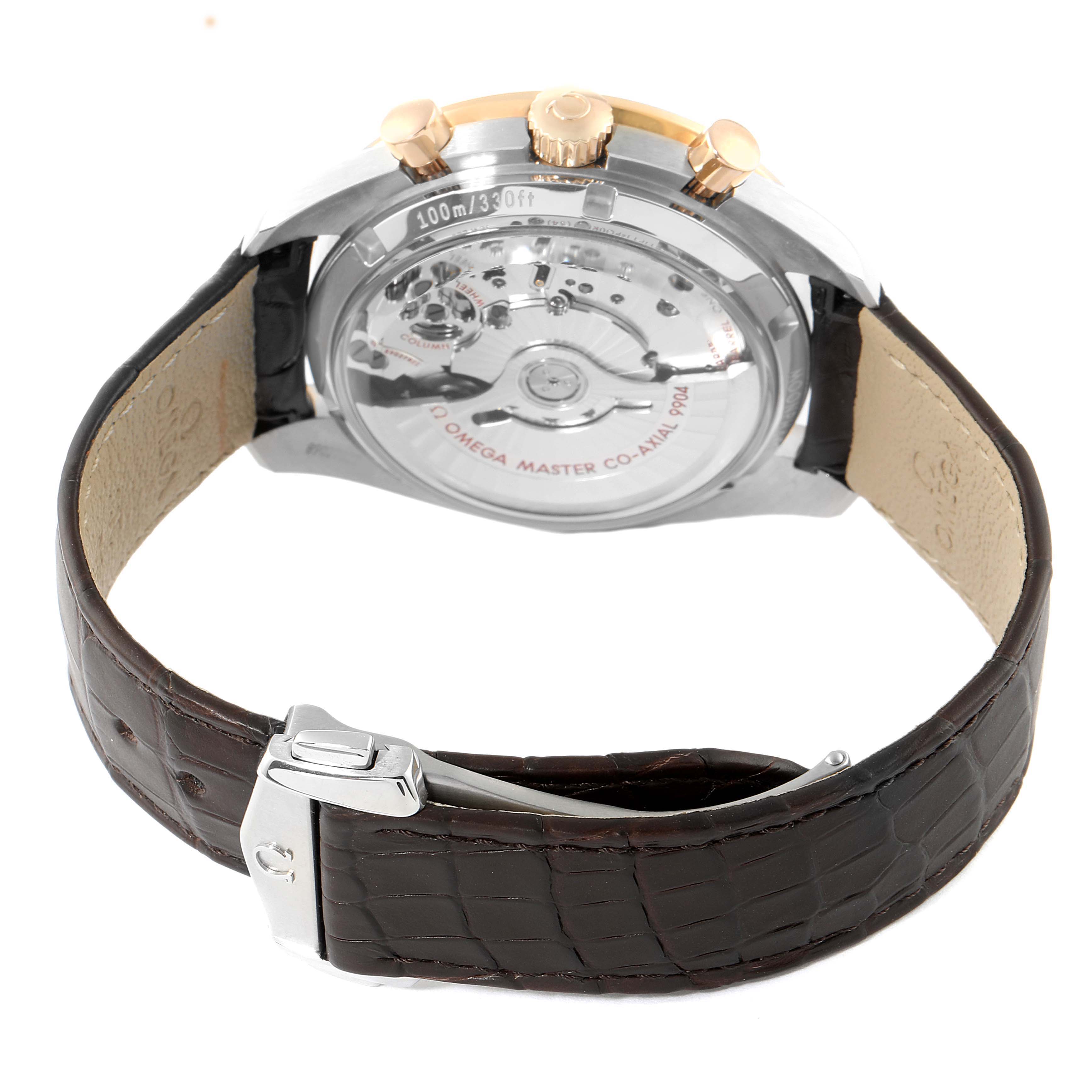 The image shows the back view of an Omega Speedmaster 304.23.44.52.13.001 Men's Steel and Gold (two tone) Brown Dial 304.23.44.52.13.001 Men's Steel and Gold (two tone) Brown Dial, highlighting its transparent case back and brown leather strap.