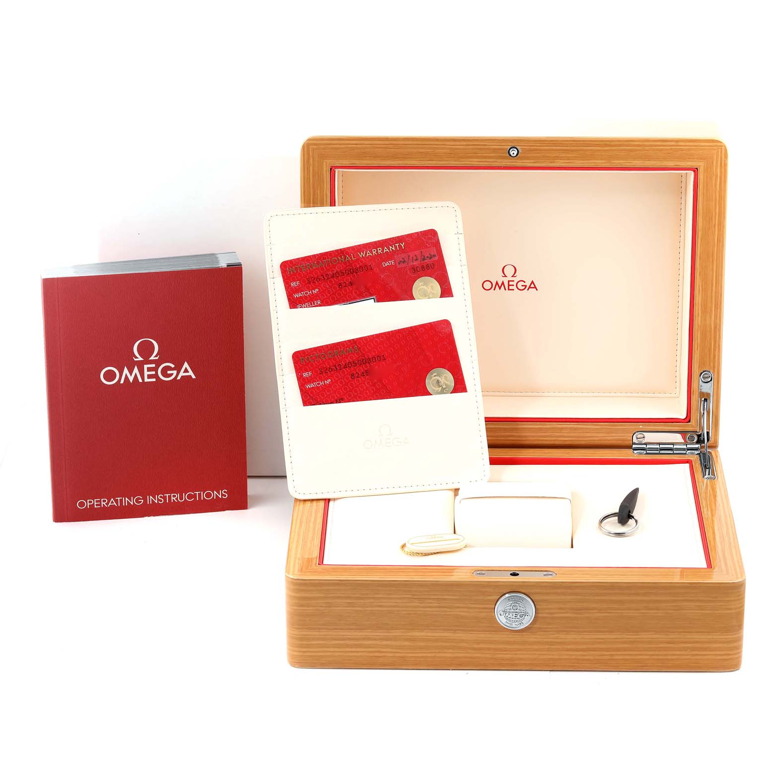 The image shows the packaging and accessories for an Omega Speedmaster 326.32.40.50.03.001 Men's Stainless Steel Blue Dial 326.32.40.50.03.001 Men's Stainless Steel Blue Dial, including the box, instruction manual, and warranty cards.