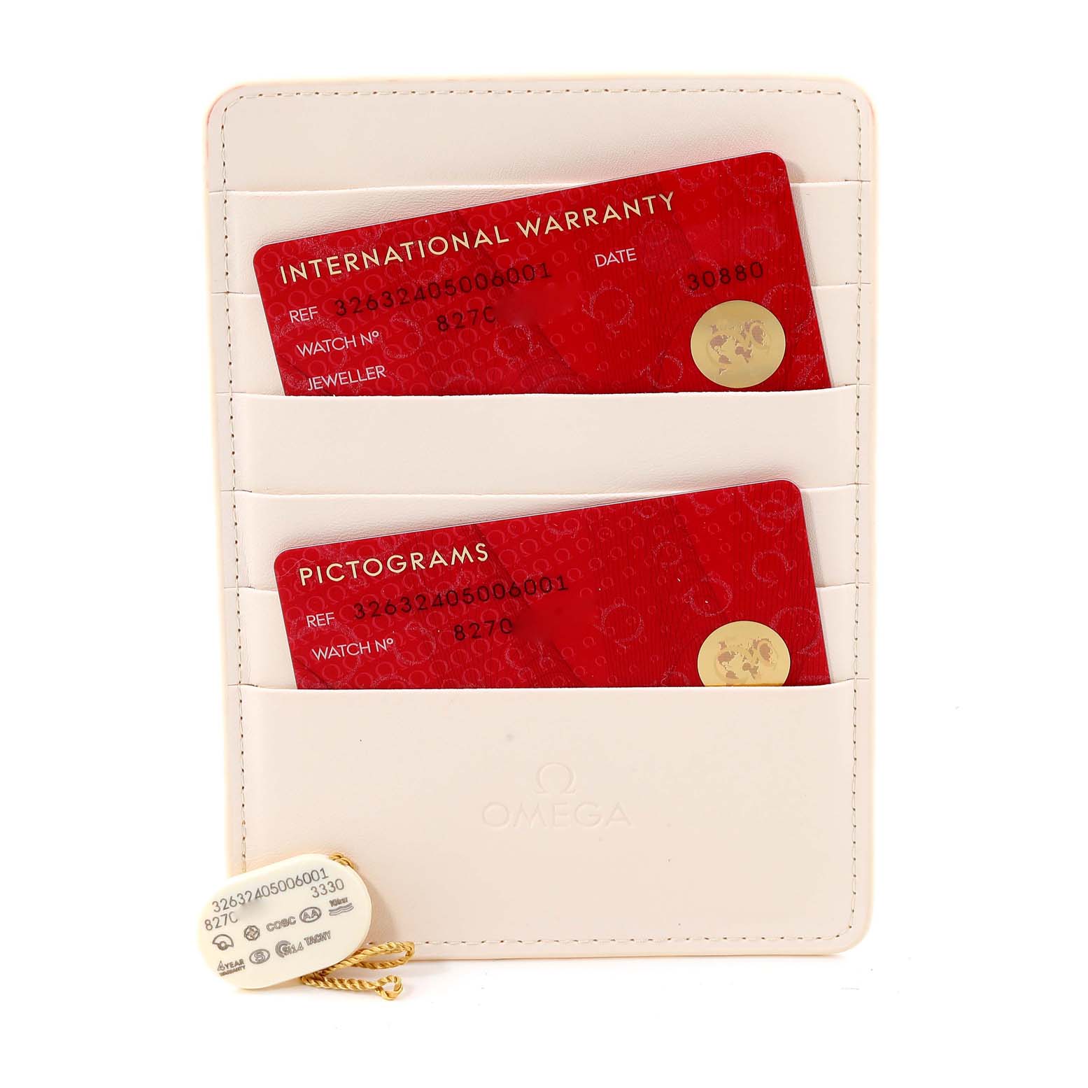 The image shows warranty and pictogram cards for an Omega Speedmaster 326.32.40.50.06.001 Men's Stainless Steel Grey Dial 326.32.40.50.06.001 Men's Stainless Steel Grey Dial, along with a tag, inside a white cardholder.