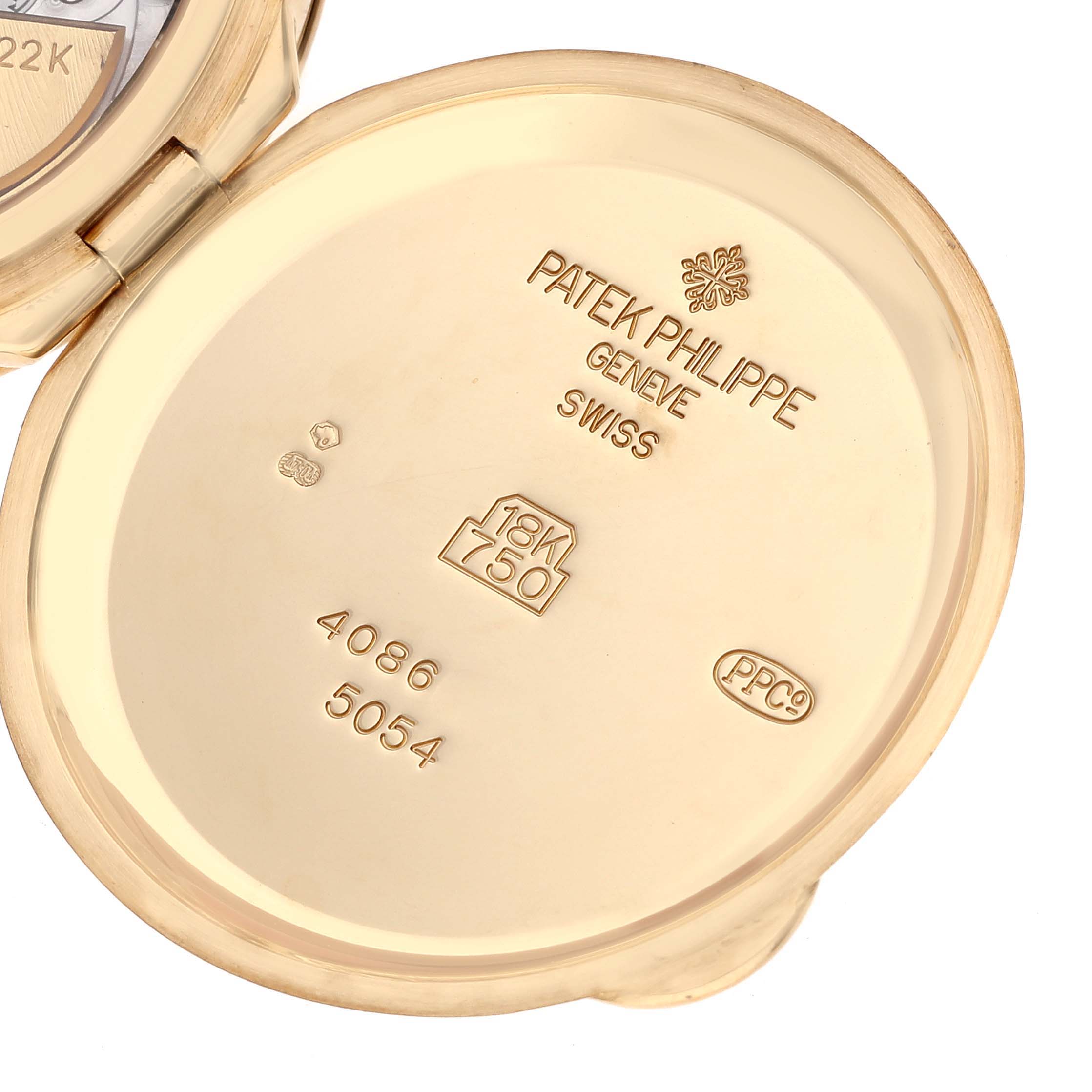 The image shows the inside caseback of a Patek Philippe Complications 5054 Men's Yellow Gold White Dial 5054 Men's Yellow Gold White Dial watch, displaying hallmark stamps and inscriptions.
