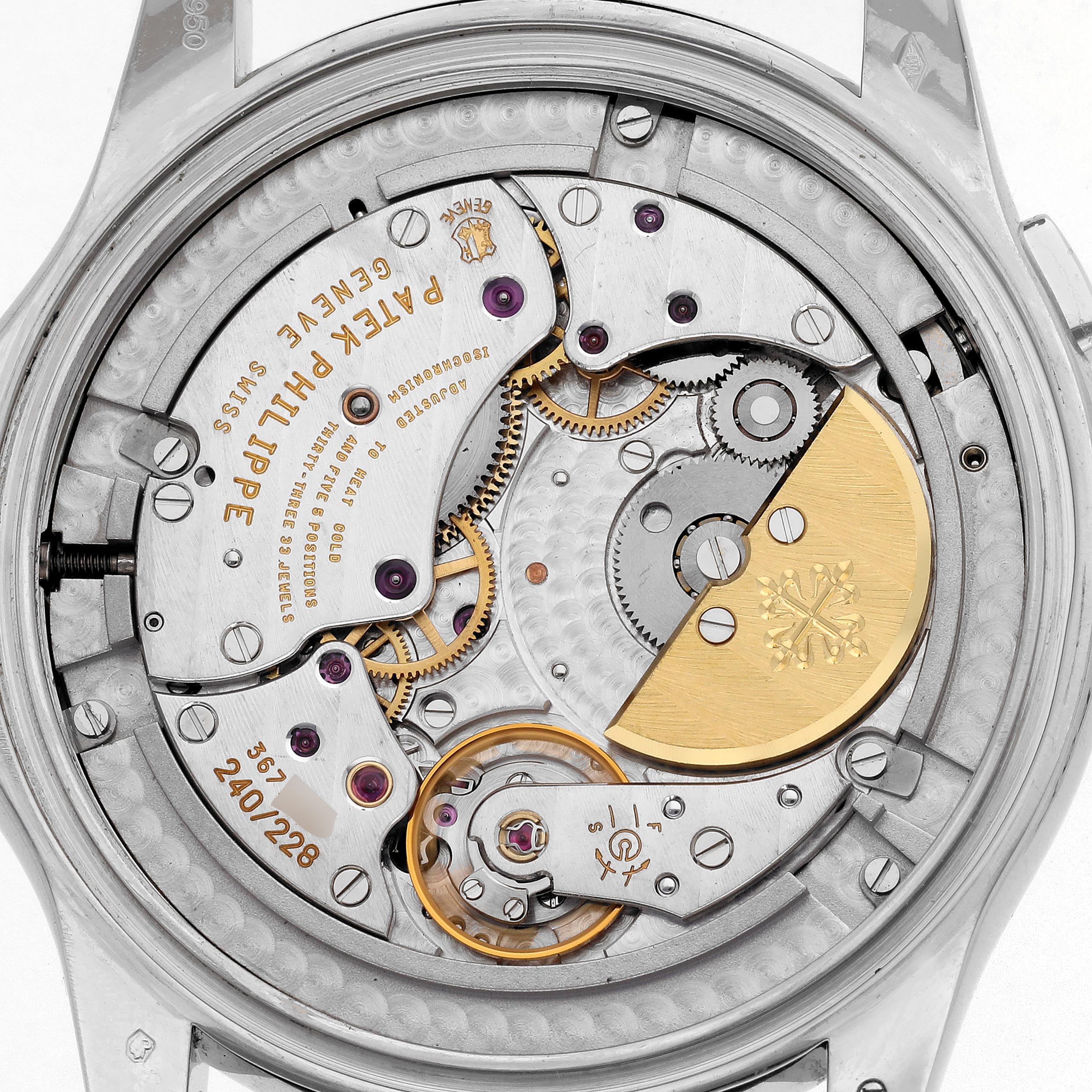 The image shows the intricate movement of a Patek Philippe Complications 5130P Men
s Platinum Silver Dial 5130P Men
s Platinum Silver Dial watch from the back, highlighting gears and engravings.