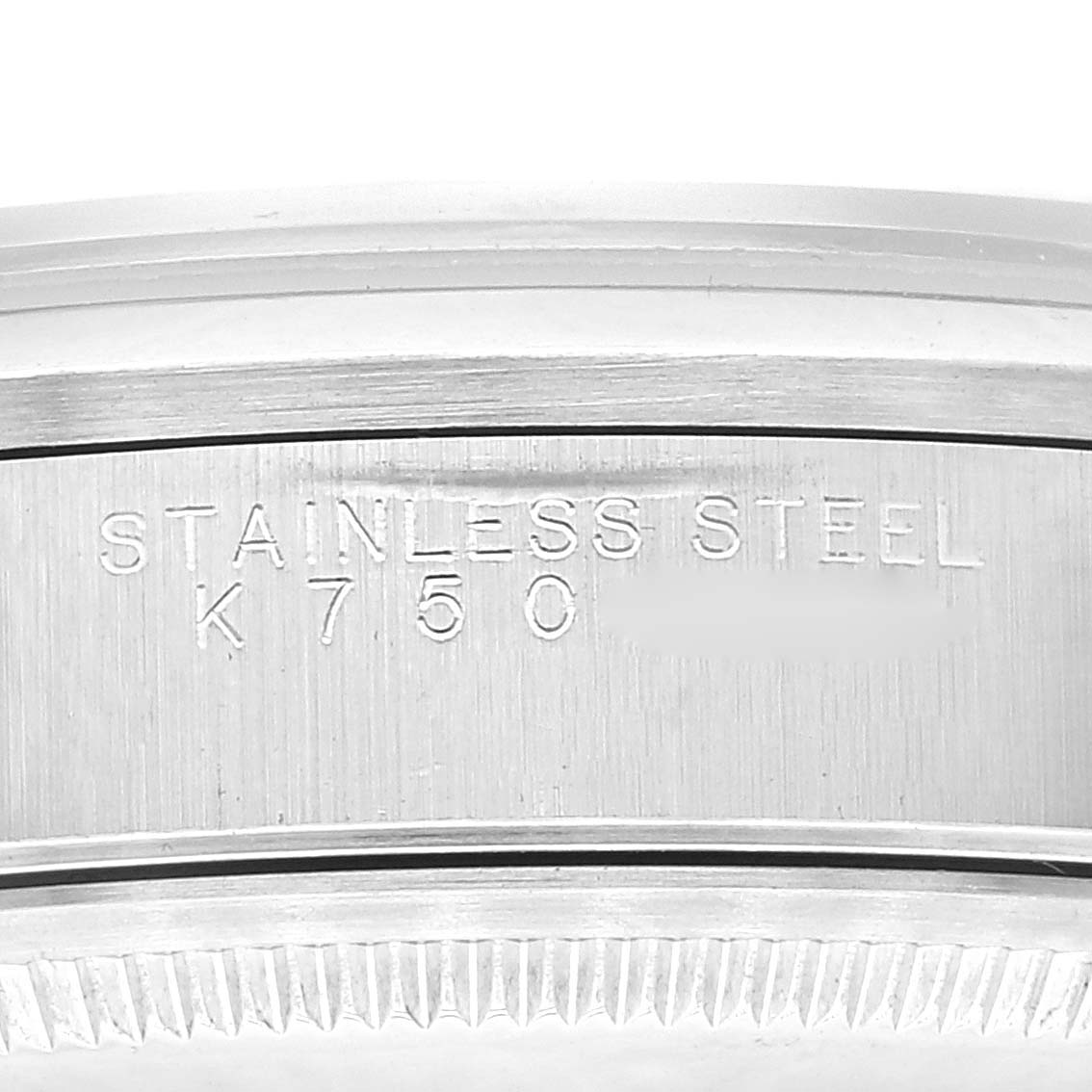 This close-up image shows the side of the stainless steel case of a Rolex Air-King 14000 Men's Stainless Steel Blue Dial 14000 Men's Stainless Steel Blue Dial watch, featuring engraved text.