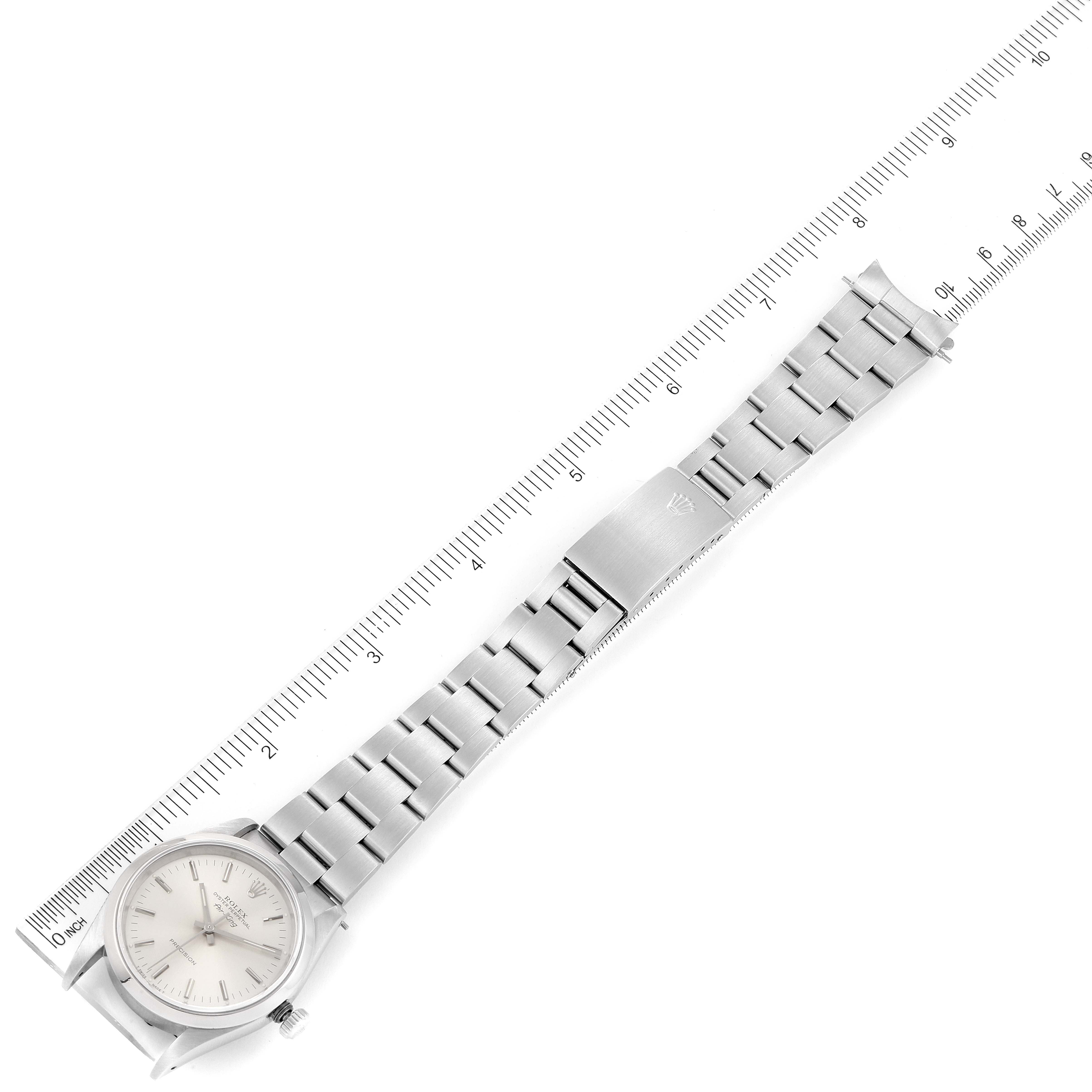 The image shows a top-down view of a Rolex Air-King 14000 Men's Stainless Steel Silver Dial 14000 Men's Stainless Steel Silver Dial watch, with its full metal bracelet and clasp extended alongside a ruler.