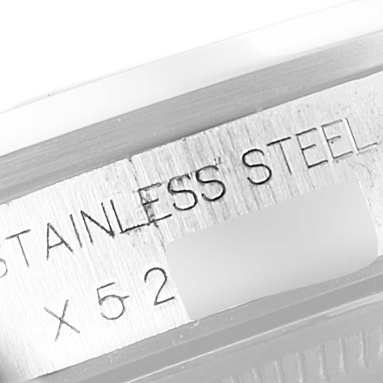 This close-up image shows part of the Rolex Air-King 14000 Men's Stainless Steel Silver Dial 14000 Men's Stainless Steel Silver Dial watch case with the "Stainless Steel" engraving and part of the serial number.