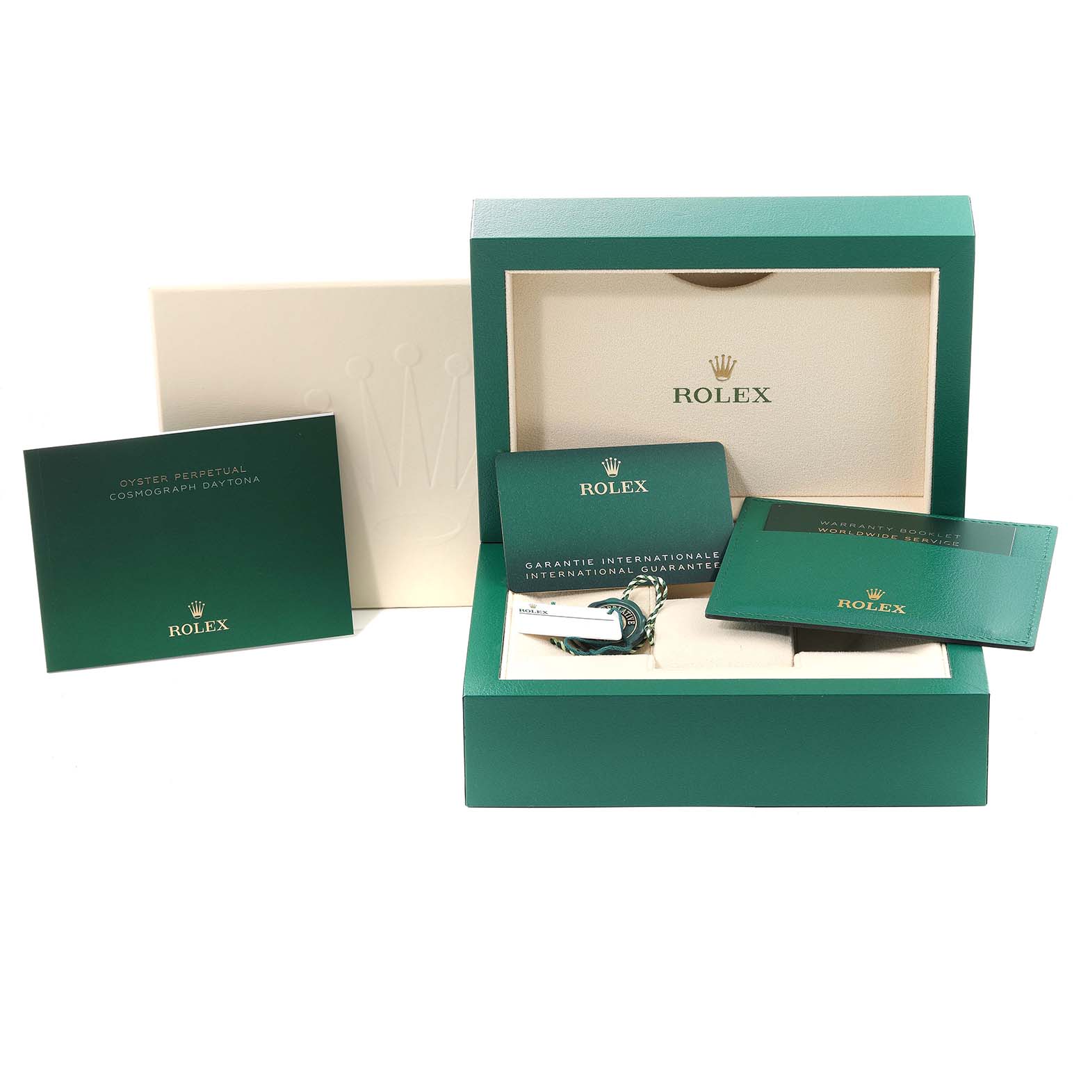 The image shows accessories for a Rolex Daytona 116500 Men
s Stainless Steel Black Dial 116500 Men
s Stainless Steel Black Dial, including the box, booklet, warranty card, and tags.