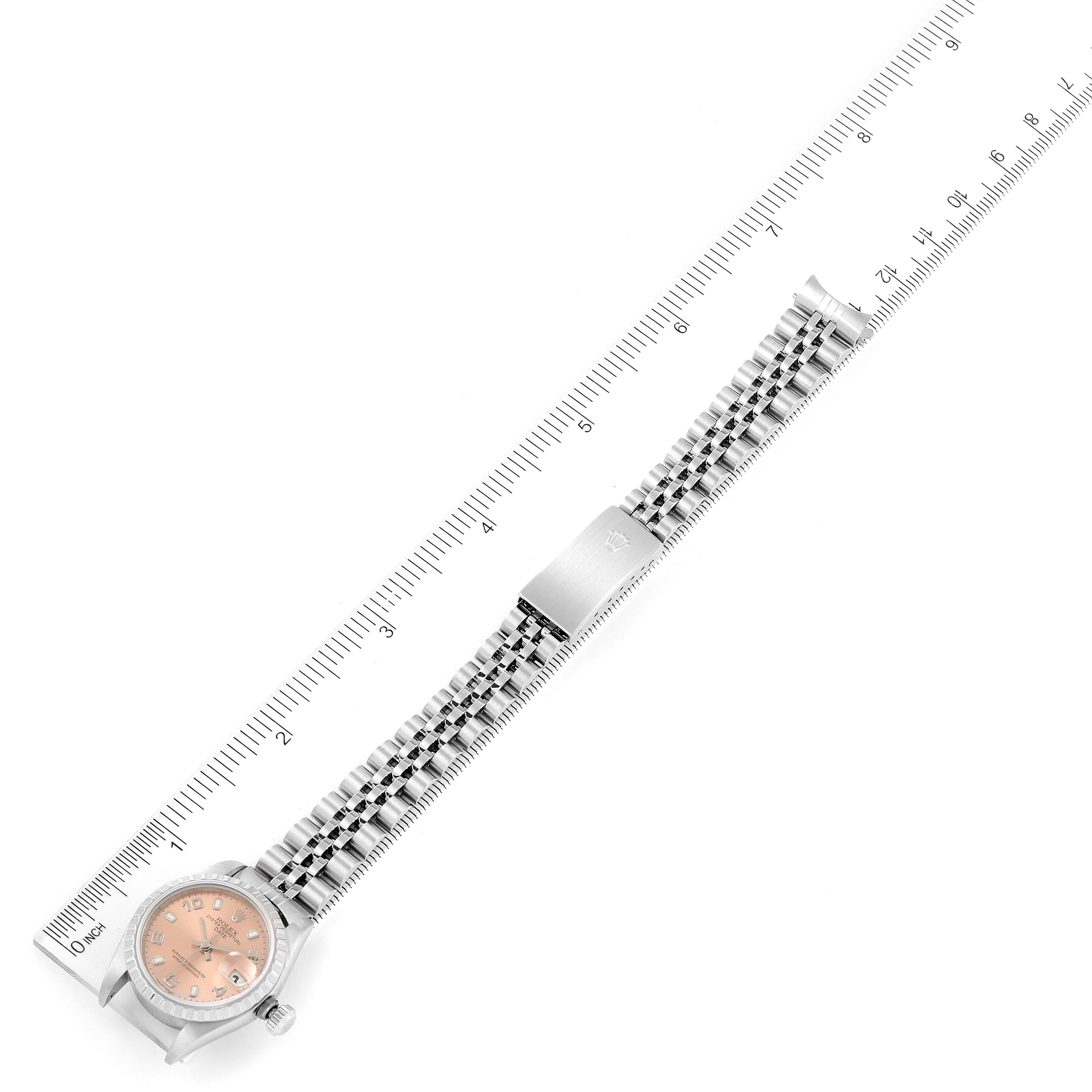 The image shows a top-down view of a Rolex Date 79240 Women's Stainless Steel Pink Dial 79240 Women's Stainless Steel Pink Dial watch, showcasing the dial, case, and band with a ruler for scale.