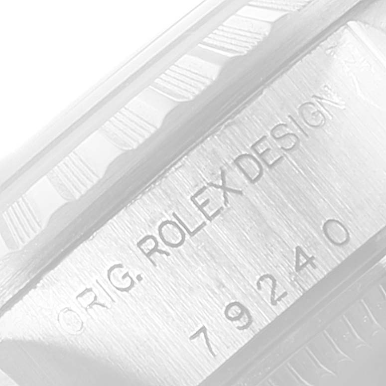 The image shows a close-up of the side of a Rolex Date 79240 Women's Stainless Steel Pink Dial 79240 Women's Stainless Steel Pink Dial watch, displaying its engraved model number and design details.